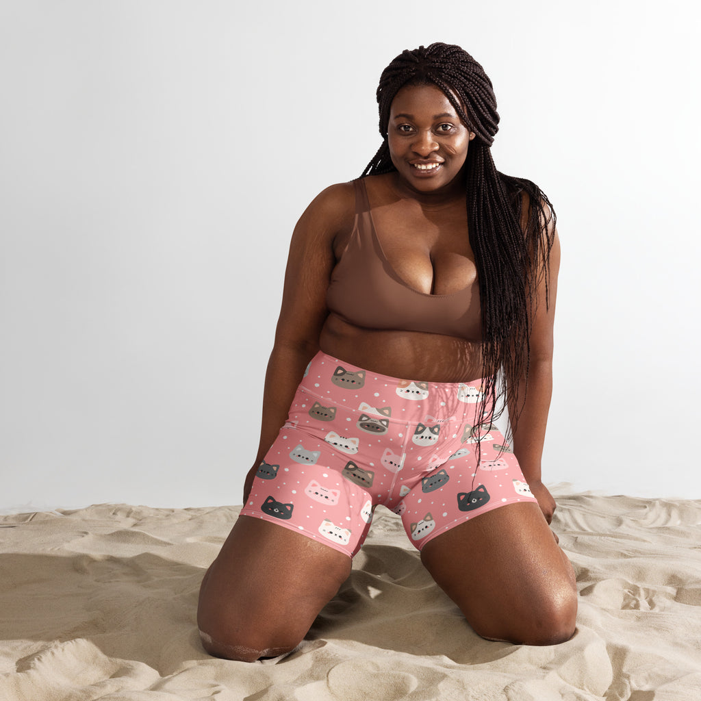Women’s high waisted buttery soft pink yoga shorts with playful colorful cartoon cat faces pattern