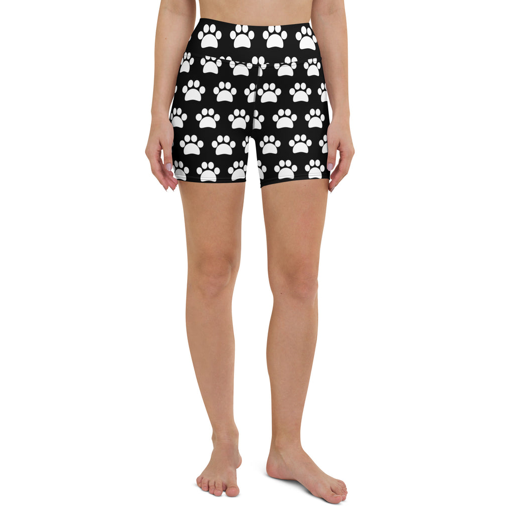 Women’s black high waisted buttery soft yoga shorts with a repeating white paw print pattern for active wear