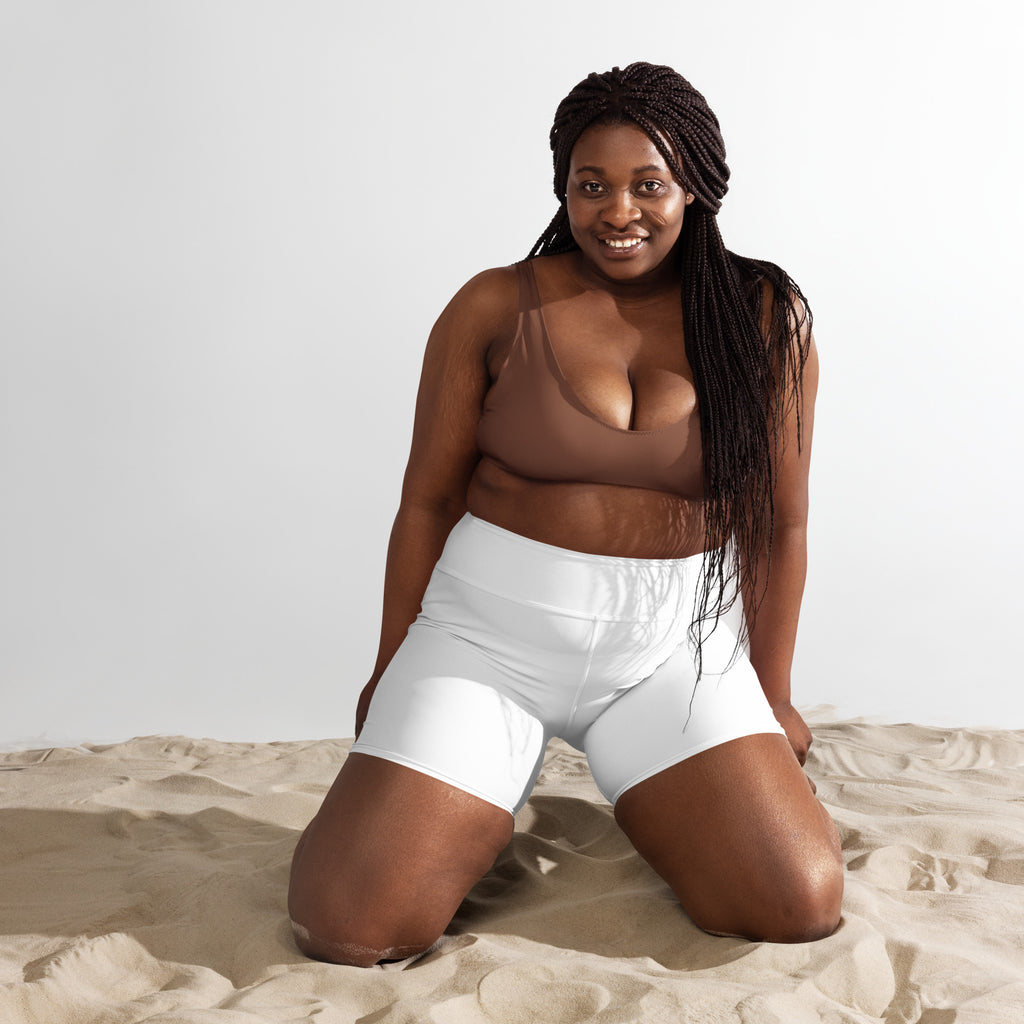 Women’s buttery soft white high-waisted yoga shorts with smooth stretchy fabric and subtle seam detail
