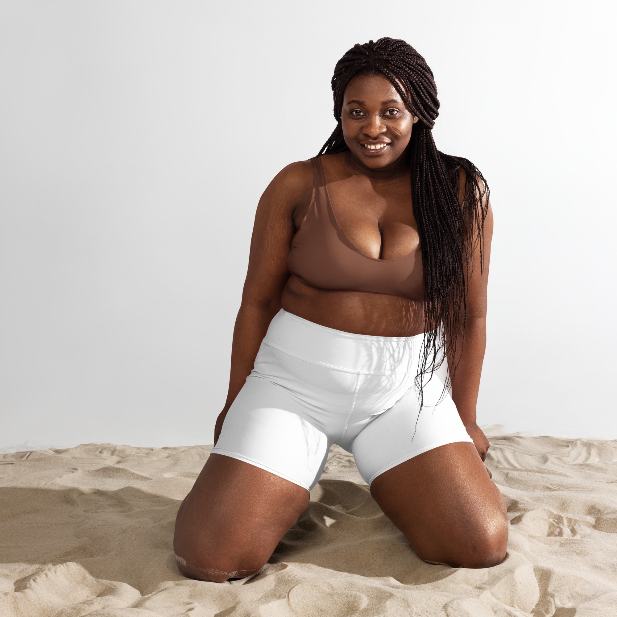 Women’s buttery soft white high-waisted yoga shorts with smooth stretchy fabric and subtle seam detail