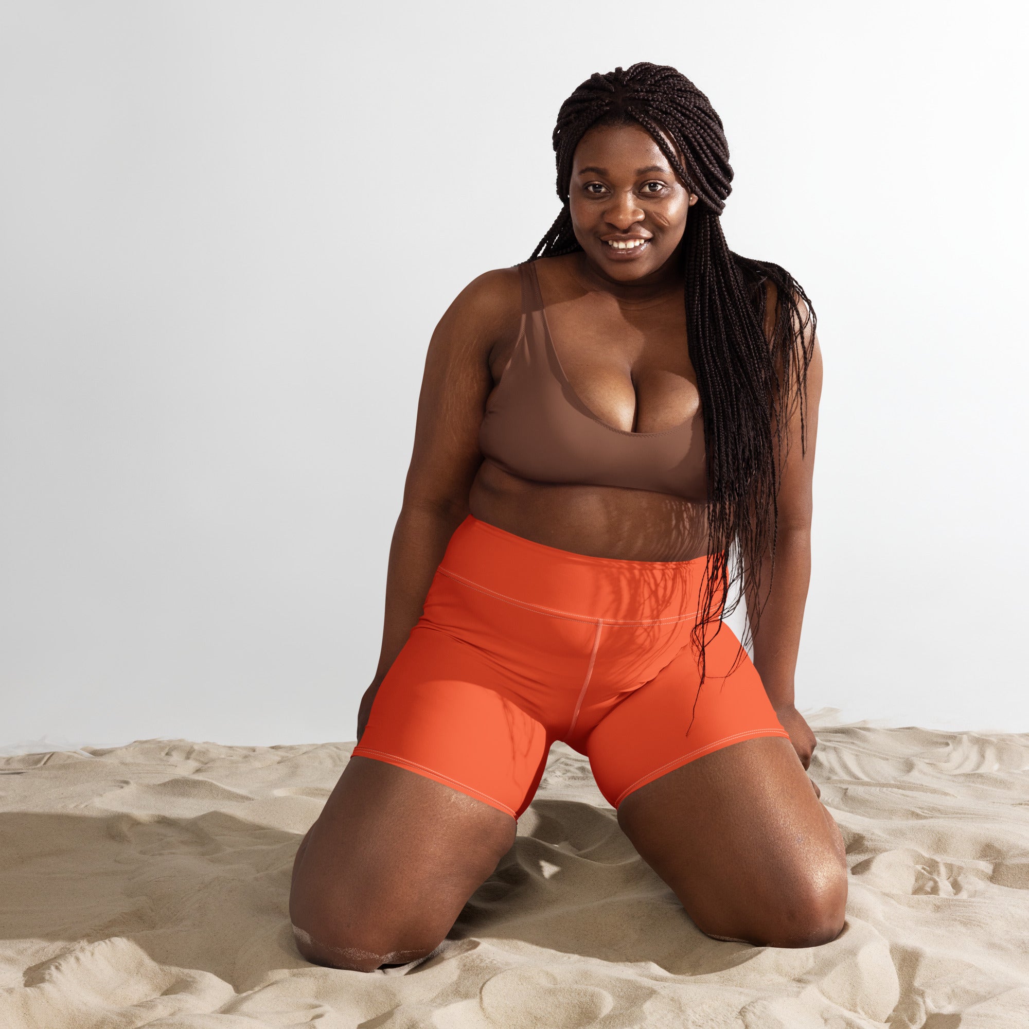 Bright orange high-waisted buttery soft yoga shorts made of smooth stretchy fabric for women’s activewear