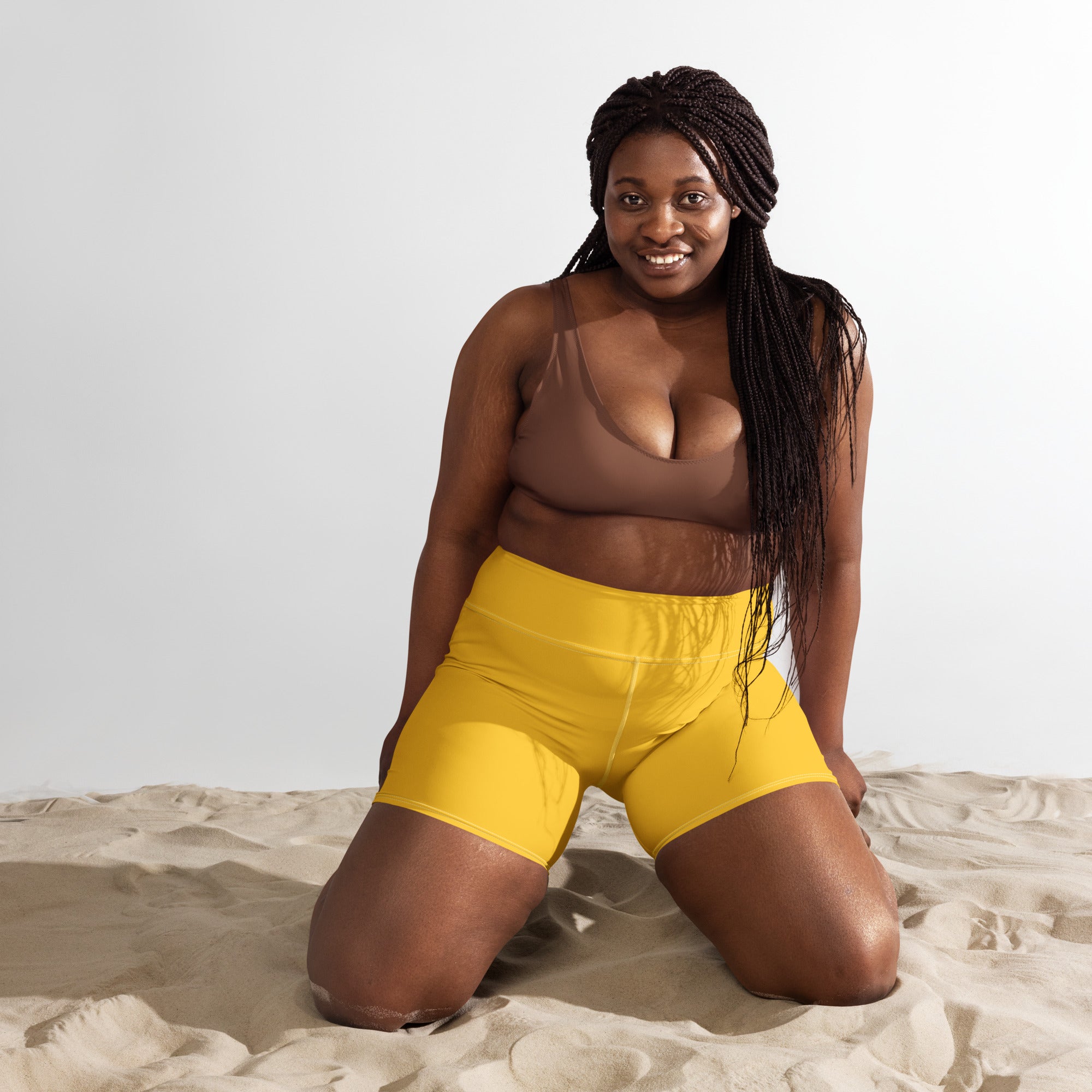 Bright yellow high waisted buttery soft yoga shorts designed for women in breathable activewear fabric