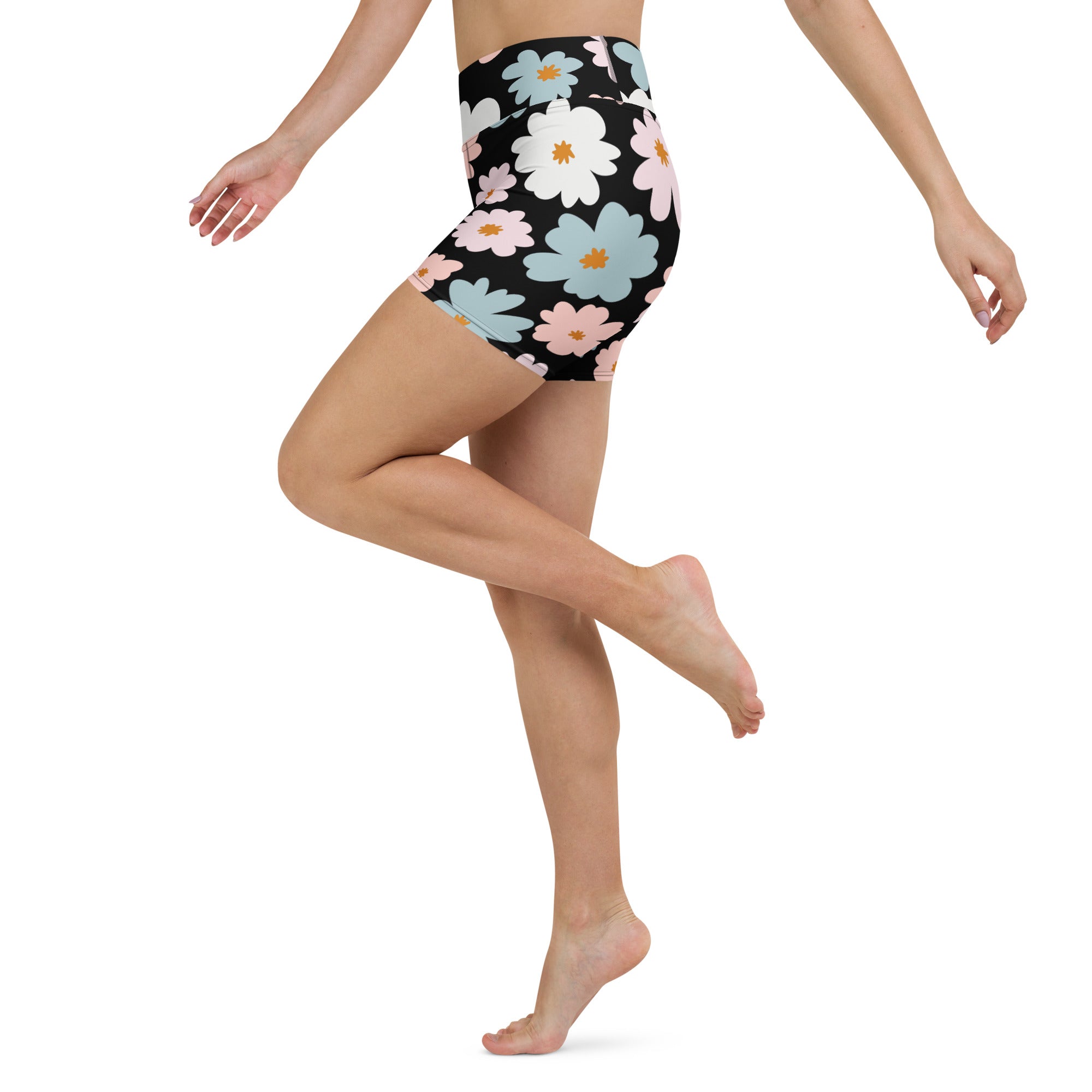 Black high-waisted women’s retro floral yoga shorts with vibrant white pink and light blue blossoms buttery soft fabric