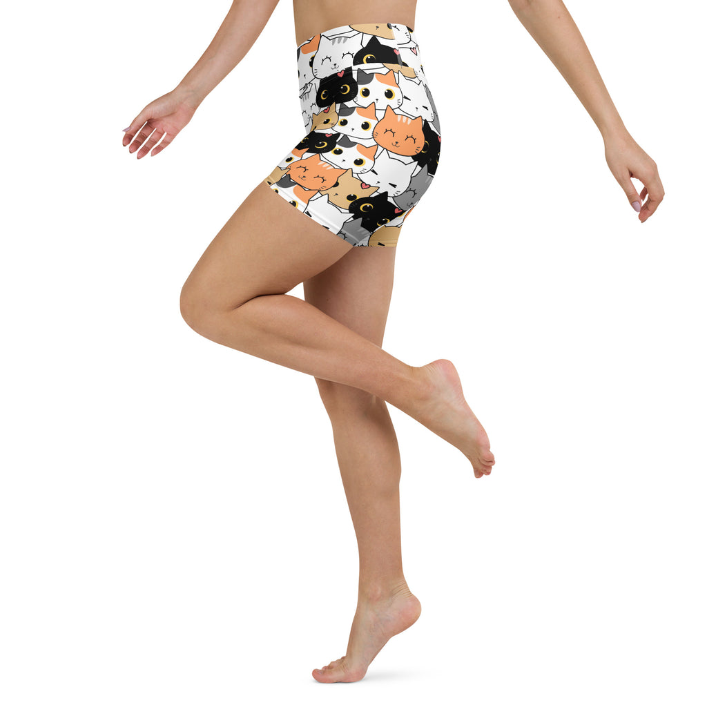 Women’s high waisted buttery soft yoga shorts with black white and orange cartoon cat face print on light background