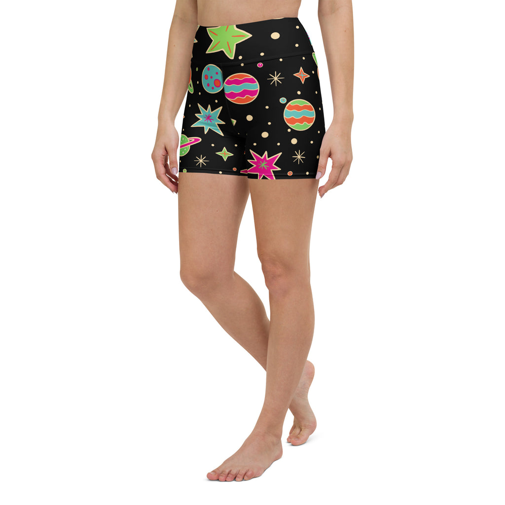 Women’s retro space yoga shorts in black high-waisted buttery soft fabric with colorful cosmic planets and stars pattern