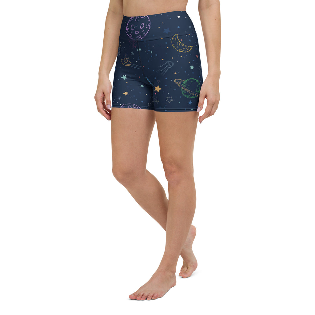 Dark blue high-waisted buttery soft yoga shorts with pastel rainbow space print featuring planets stars and rockets