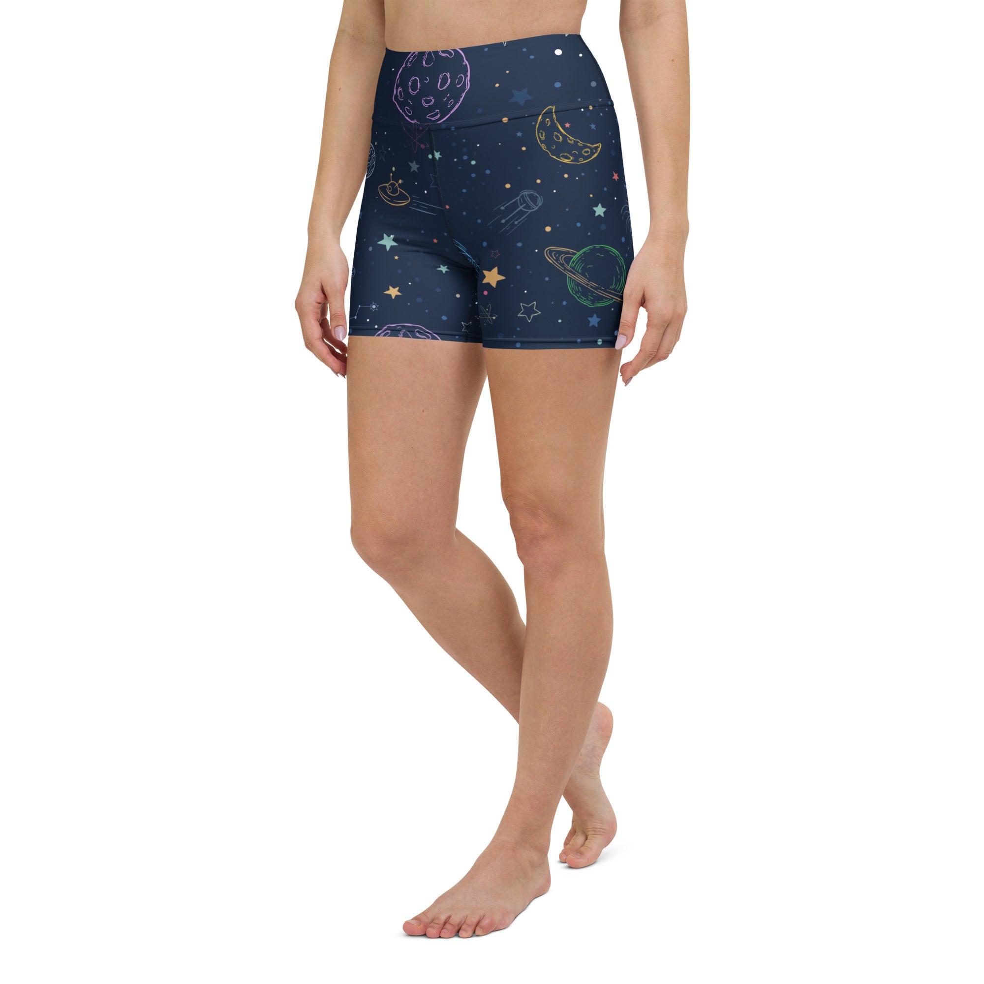 Dark blue high-waisted buttery soft yoga shorts with pastel rainbow space print featuring planets stars and rockets