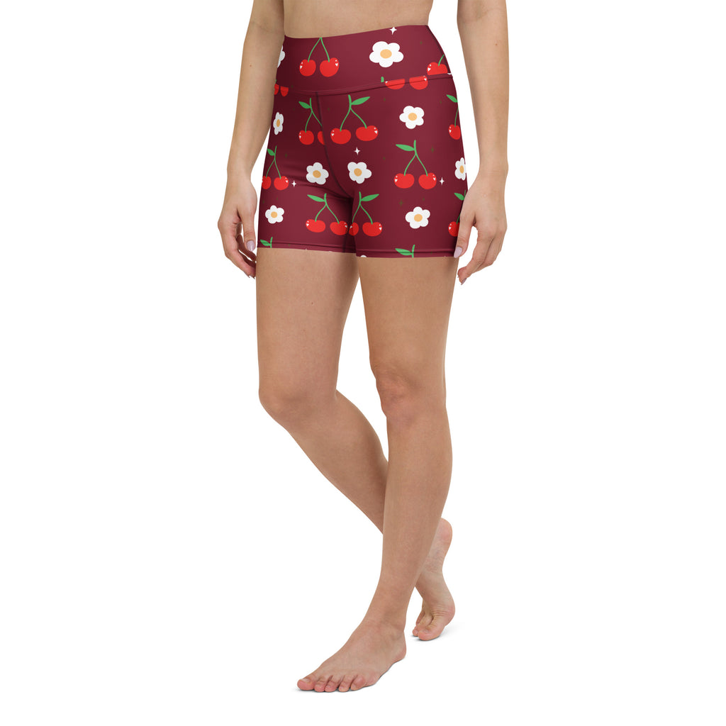 Women’s maroon high waisted cherry and daisy yoga shorts in buttery soft fabric with playful red cherries and white flowers pattern