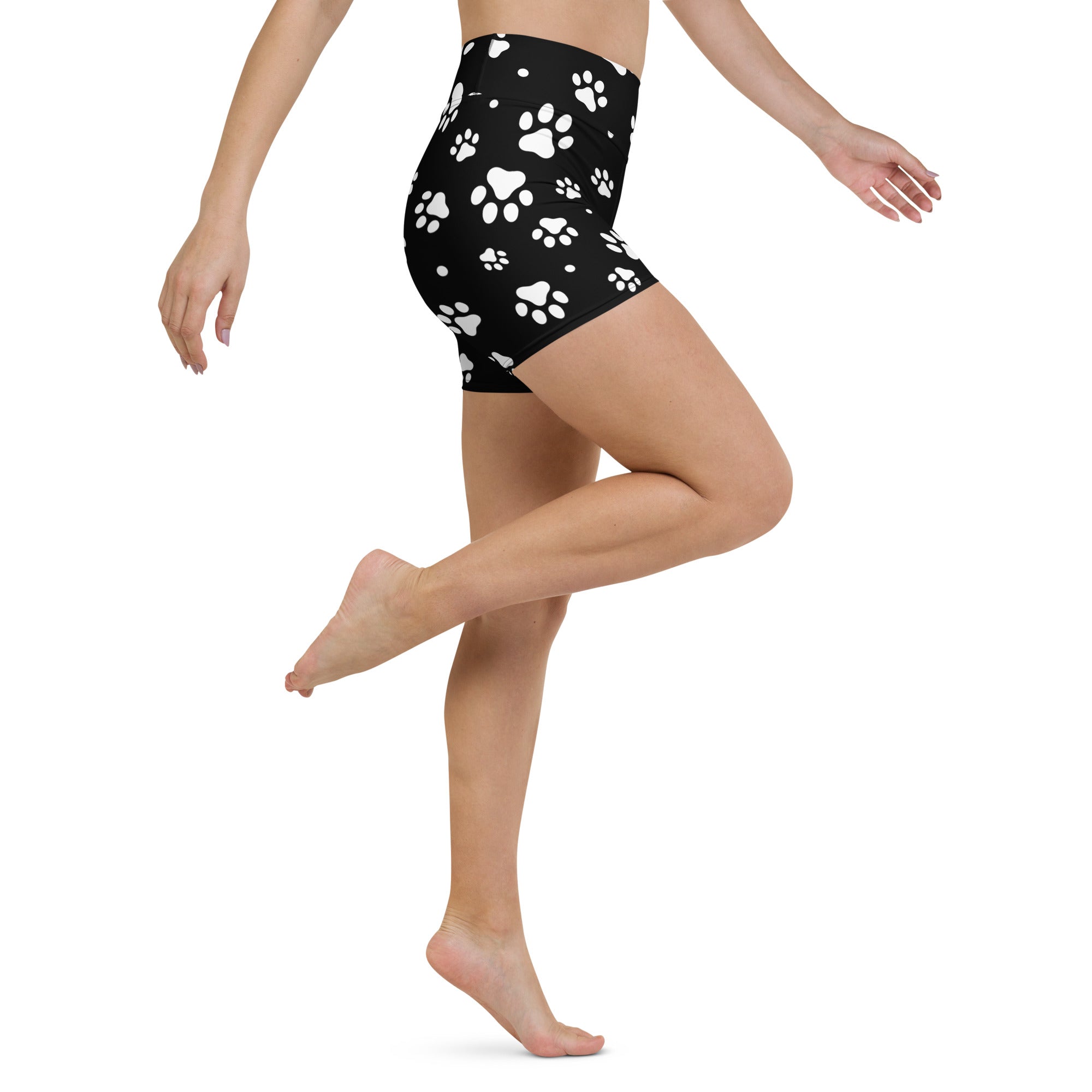 Women’s black high waisted buttery soft yoga shorts with a playful white paw print pattern for active wear