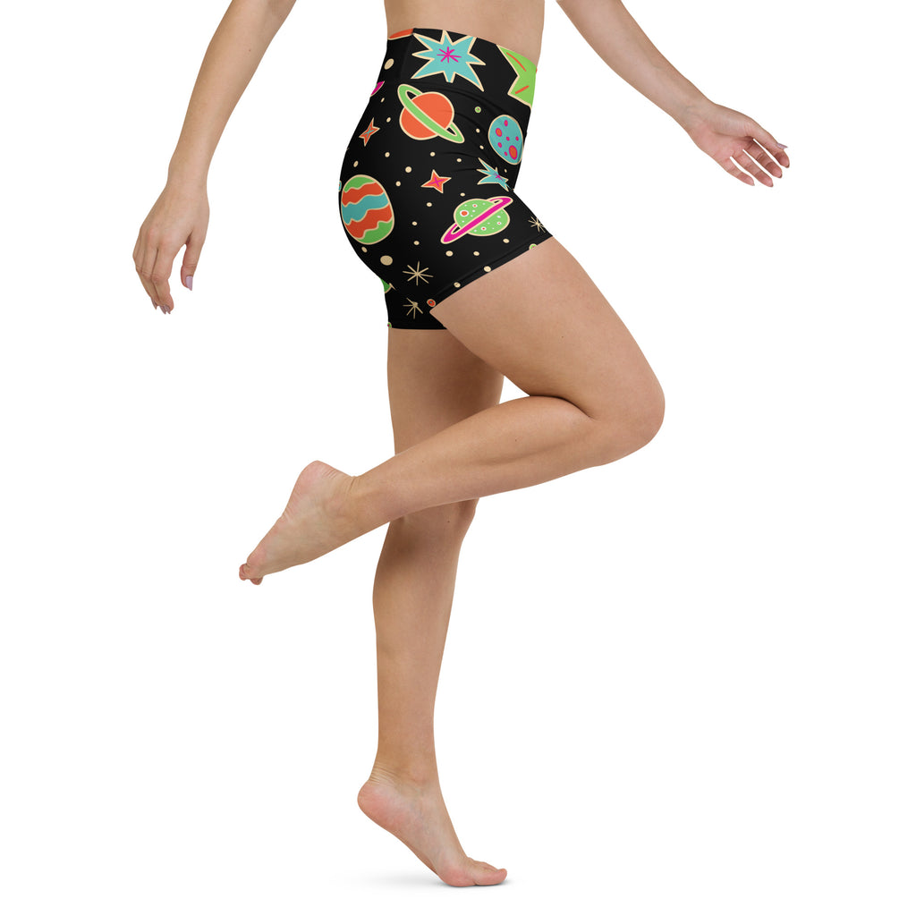 Black high-waisted buttery soft yoga shorts with a vibrant space-themed pattern of colorful planets and stars
