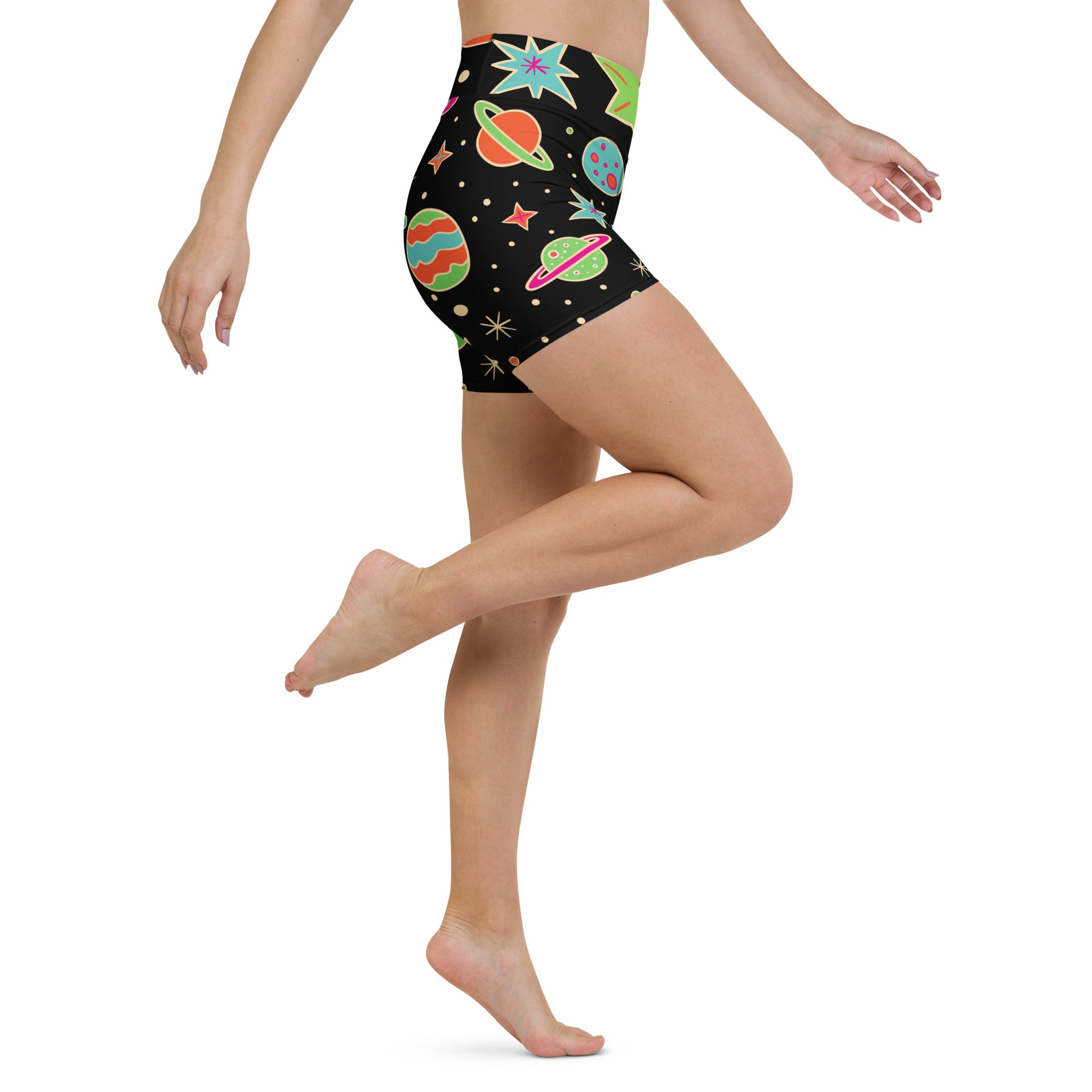Black high-waisted buttery soft yoga shorts with a vibrant space-themed pattern of colorful planets and stars