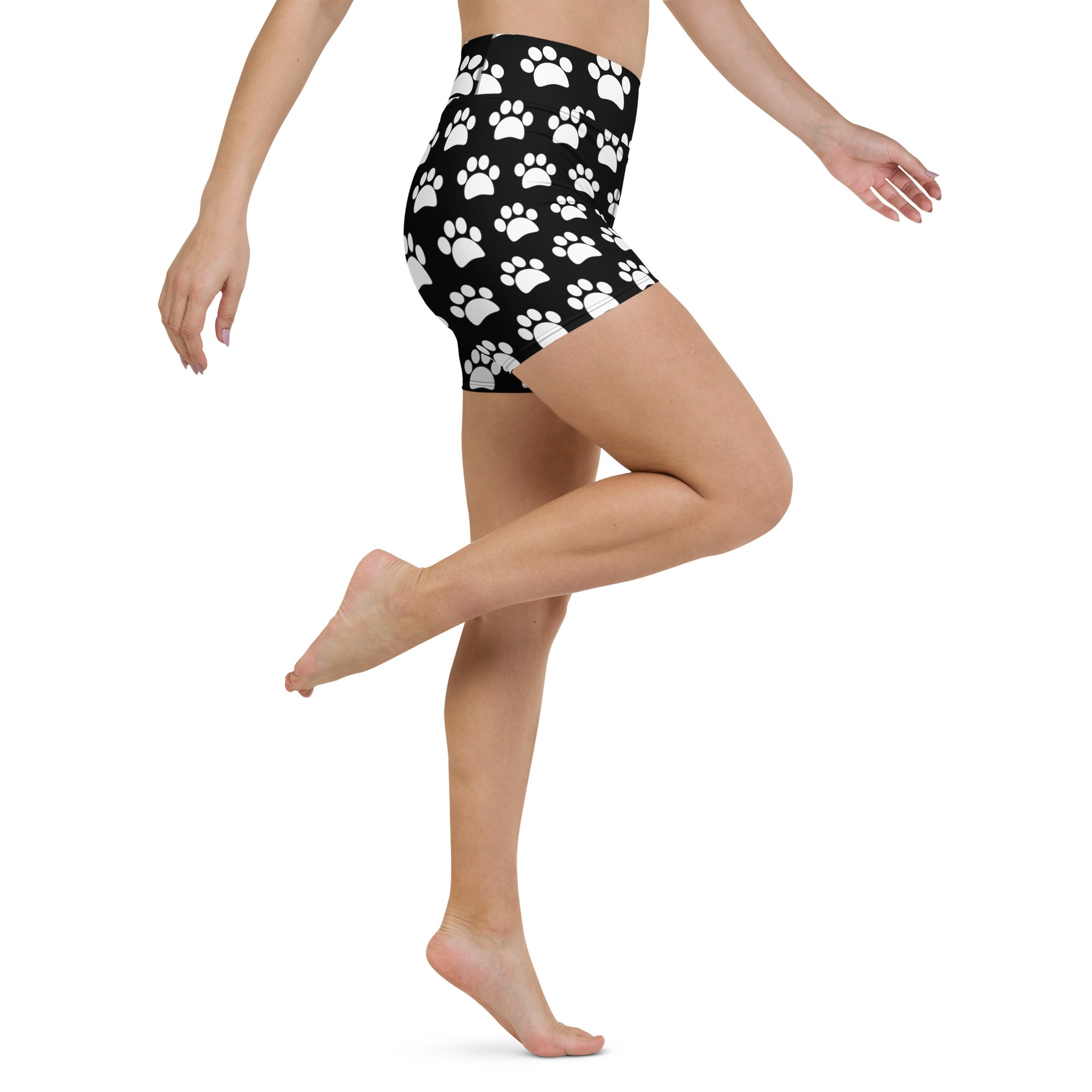 Women’s black high waisted buttery soft yoga shorts with a white paw print pattern for active wear