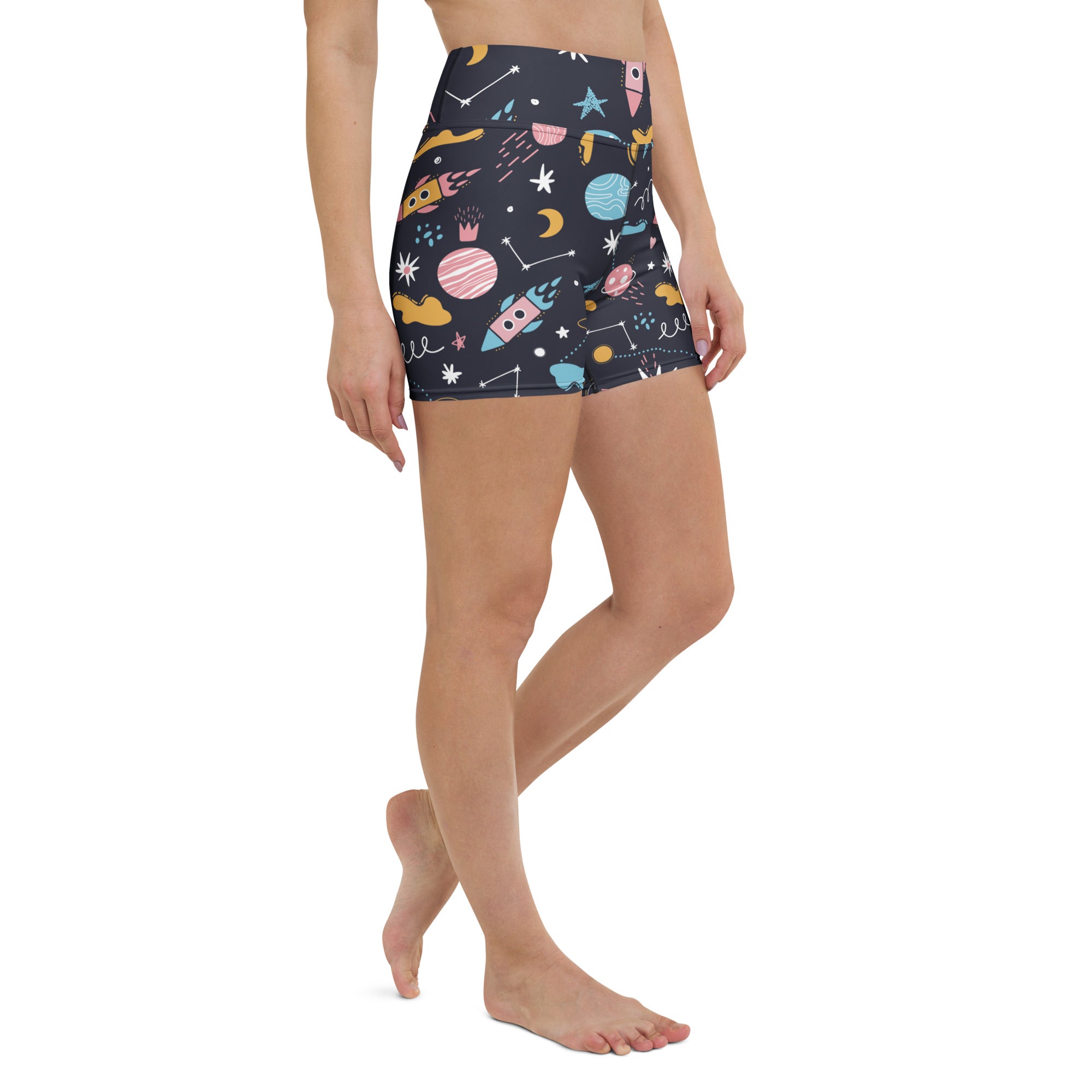 Dark blue high waisted buttery soft women’s outer space yoga shorts with colorful rockets planets stars and moons pattern