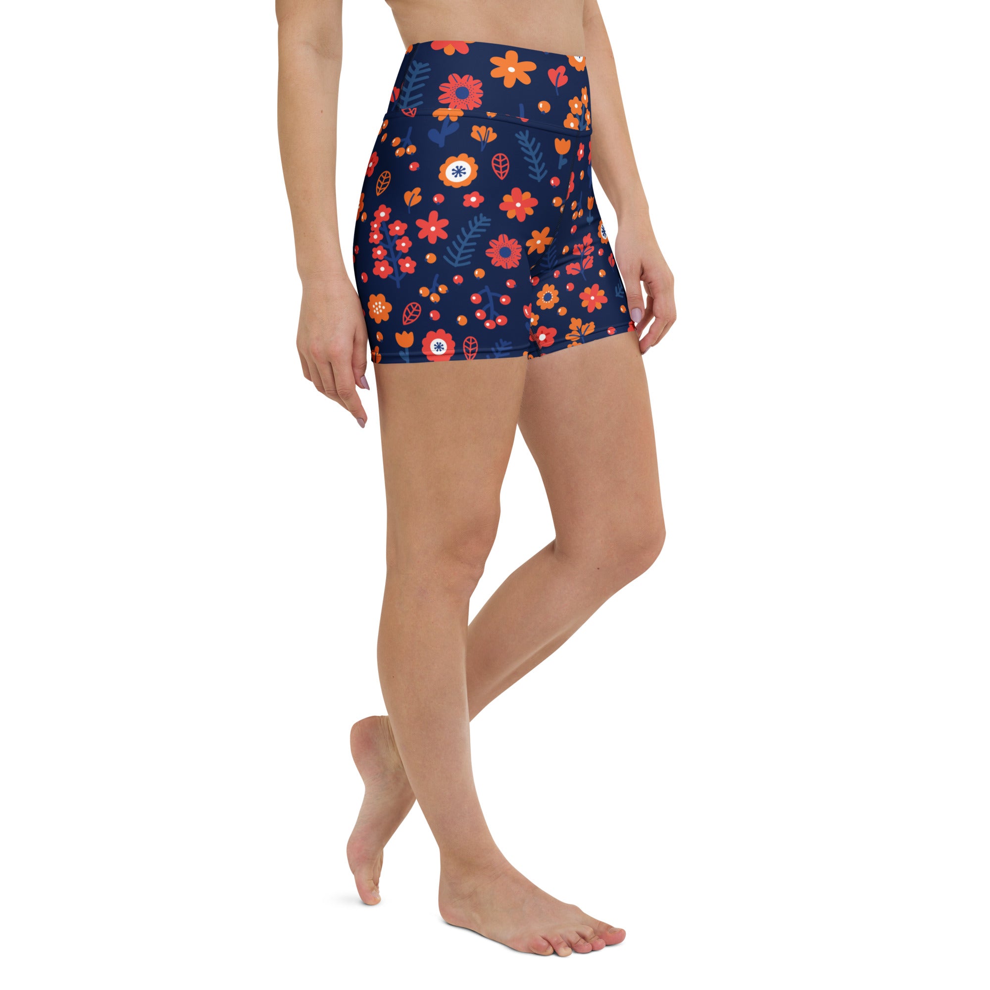 Women’s navy high waisted floral yoga shorts with vibrant orange red and white blossoms in buttery soft fabric