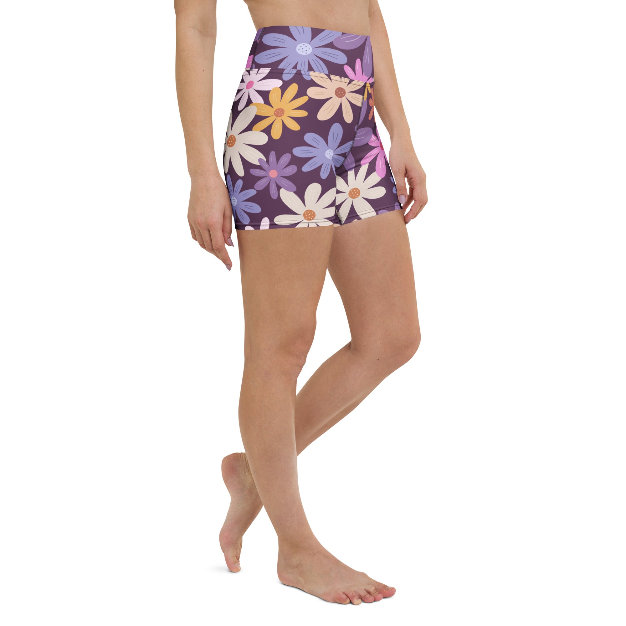 Women’s purple high waisted yoga shorts with a vibrant daisy floral pattern in buttery soft active fabric