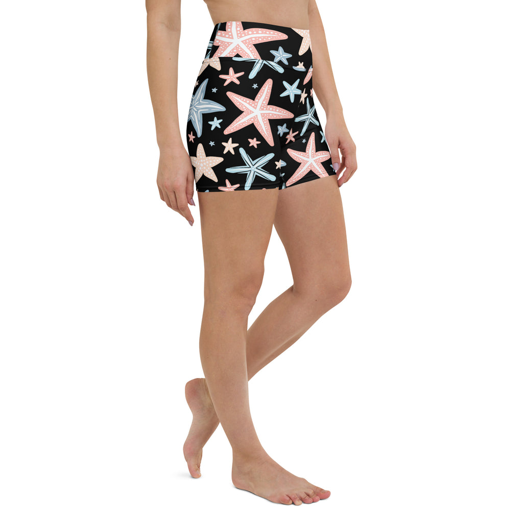 Women’s high waisted buttery soft black yoga shorts with pink and light blue starfish pattern for activewear