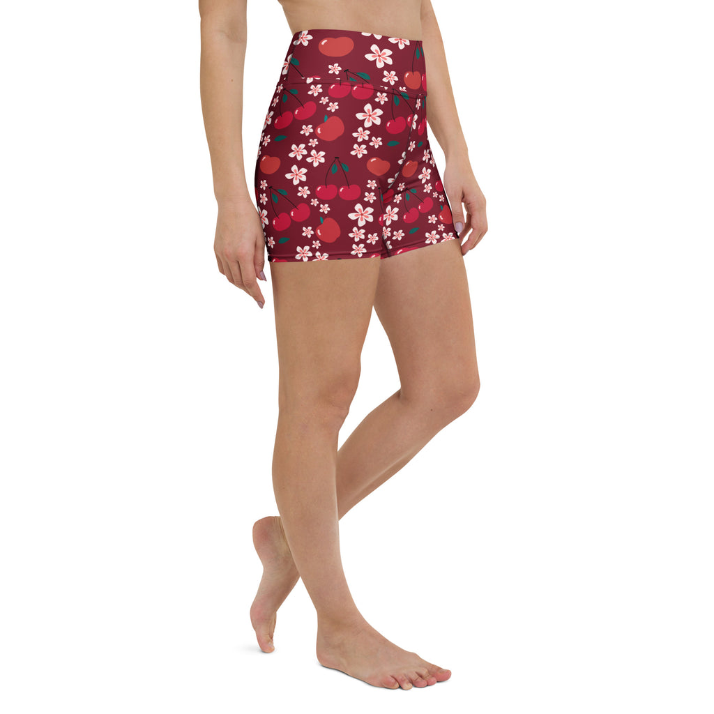 Women’s maroon high-waisted buttery soft yoga shorts with vibrant red cherries and pink cherry blossom pattern