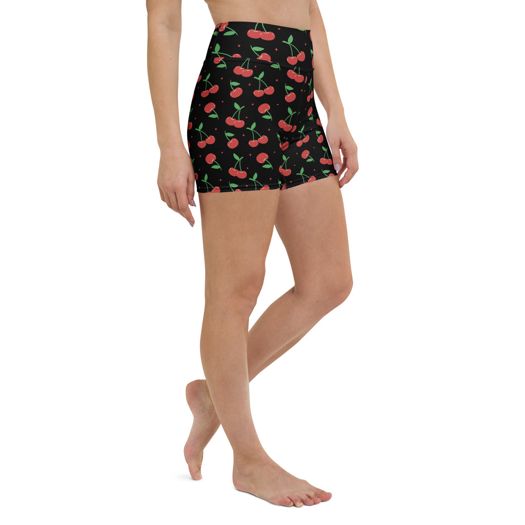 Women’s black high waisted buttery soft yoga shorts with vibrant red and green cherry pattern for active wear