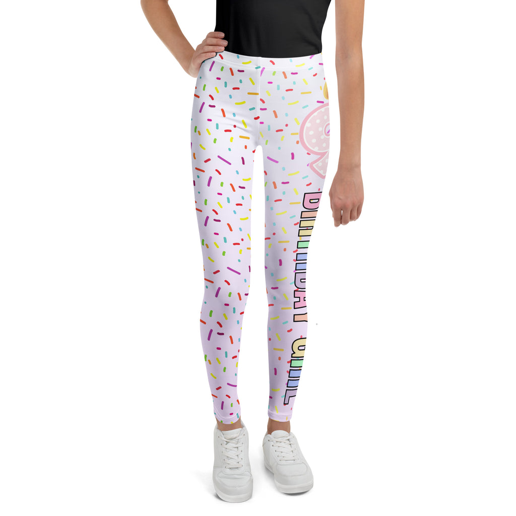 White buttery soft leggings with colorful sprinkles pink donut graphic and birthday in rainbow lettering on side