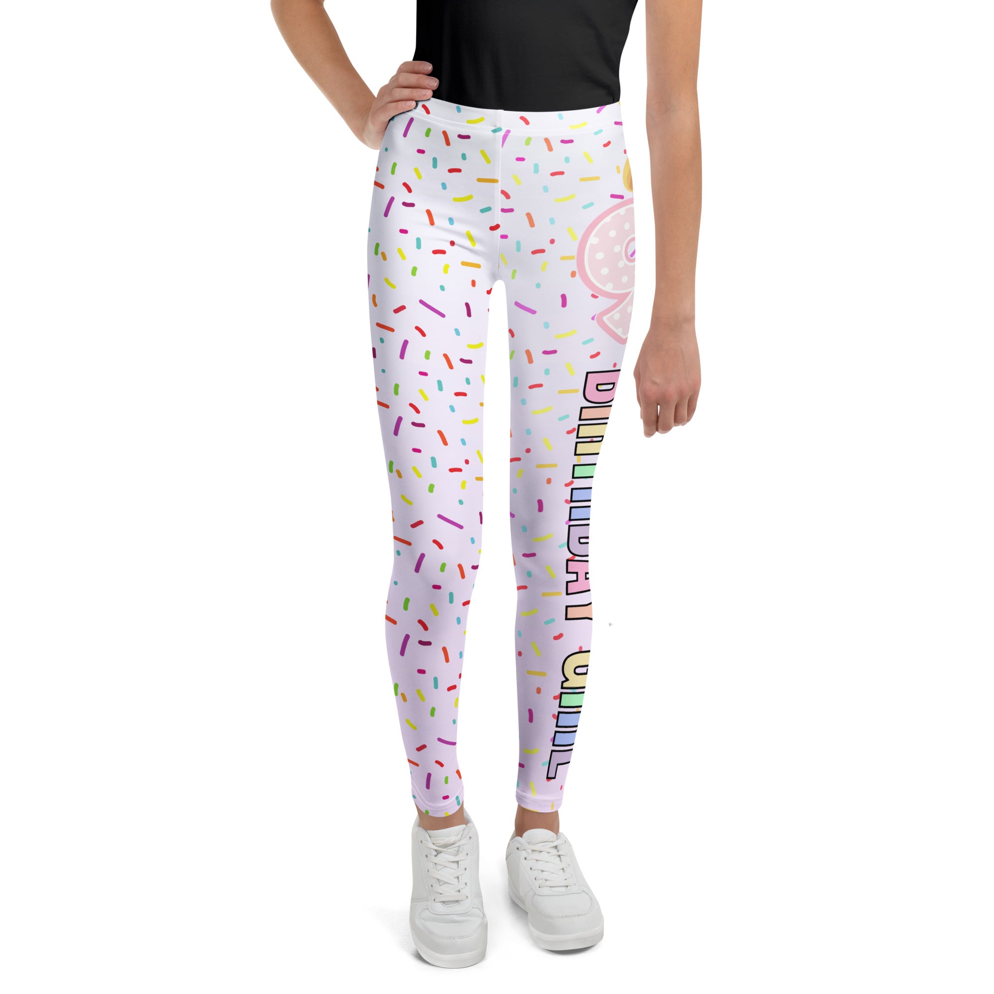 White buttery soft leggings with colorful sprinkles pink donut graphic and birthday in rainbow lettering on side