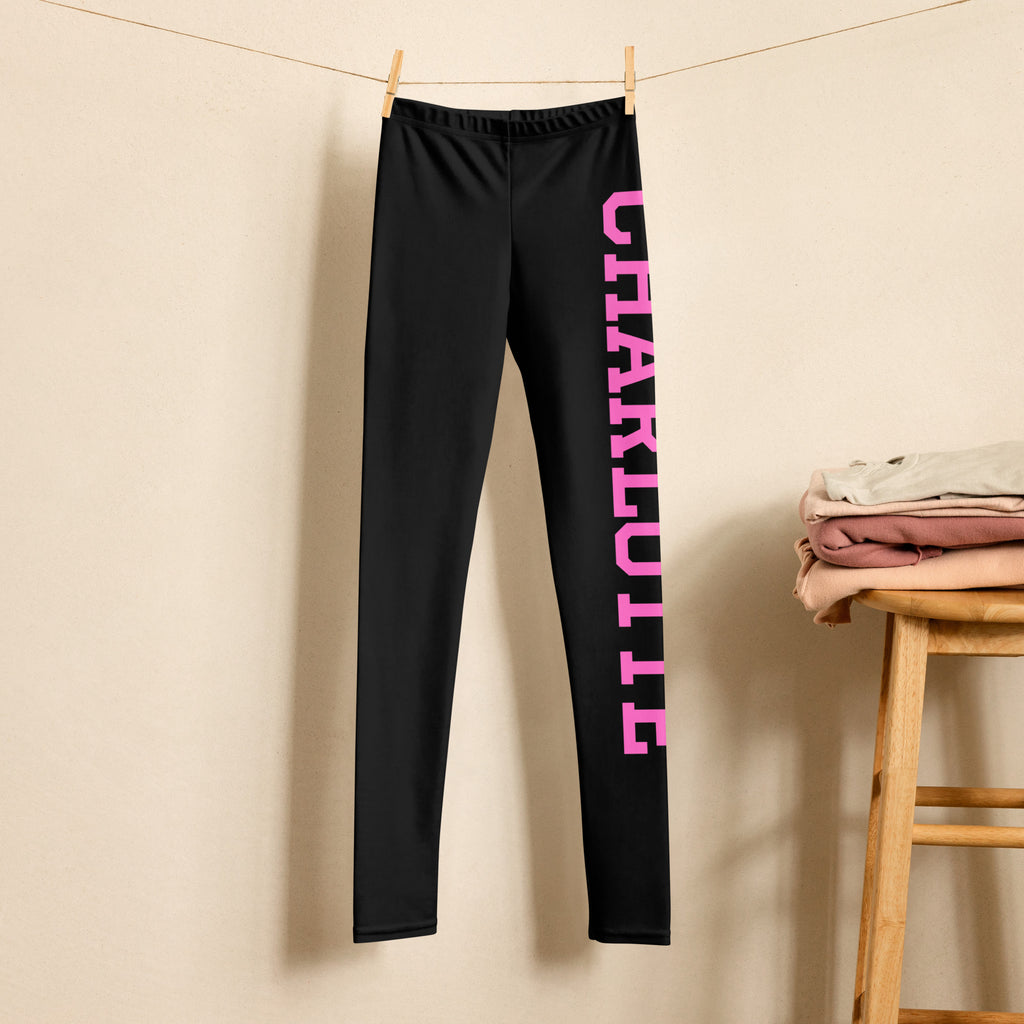 Black girls sports leggings with bold pink charlotte varsity font lettering down the outer leg buttery soft material