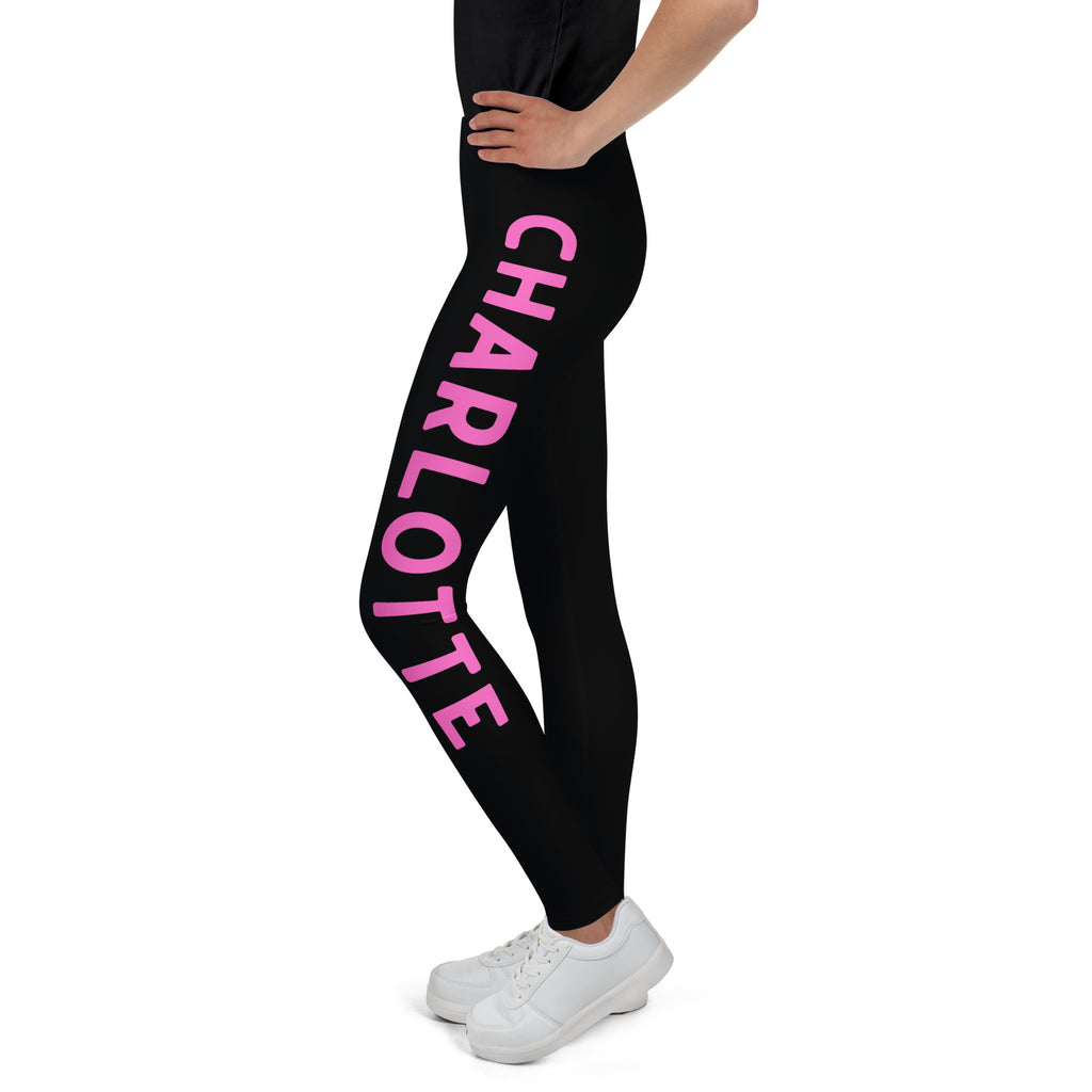 Girls custom color and name buttery soft black leggings with bold pink charlotte lettering on the outer thigh
