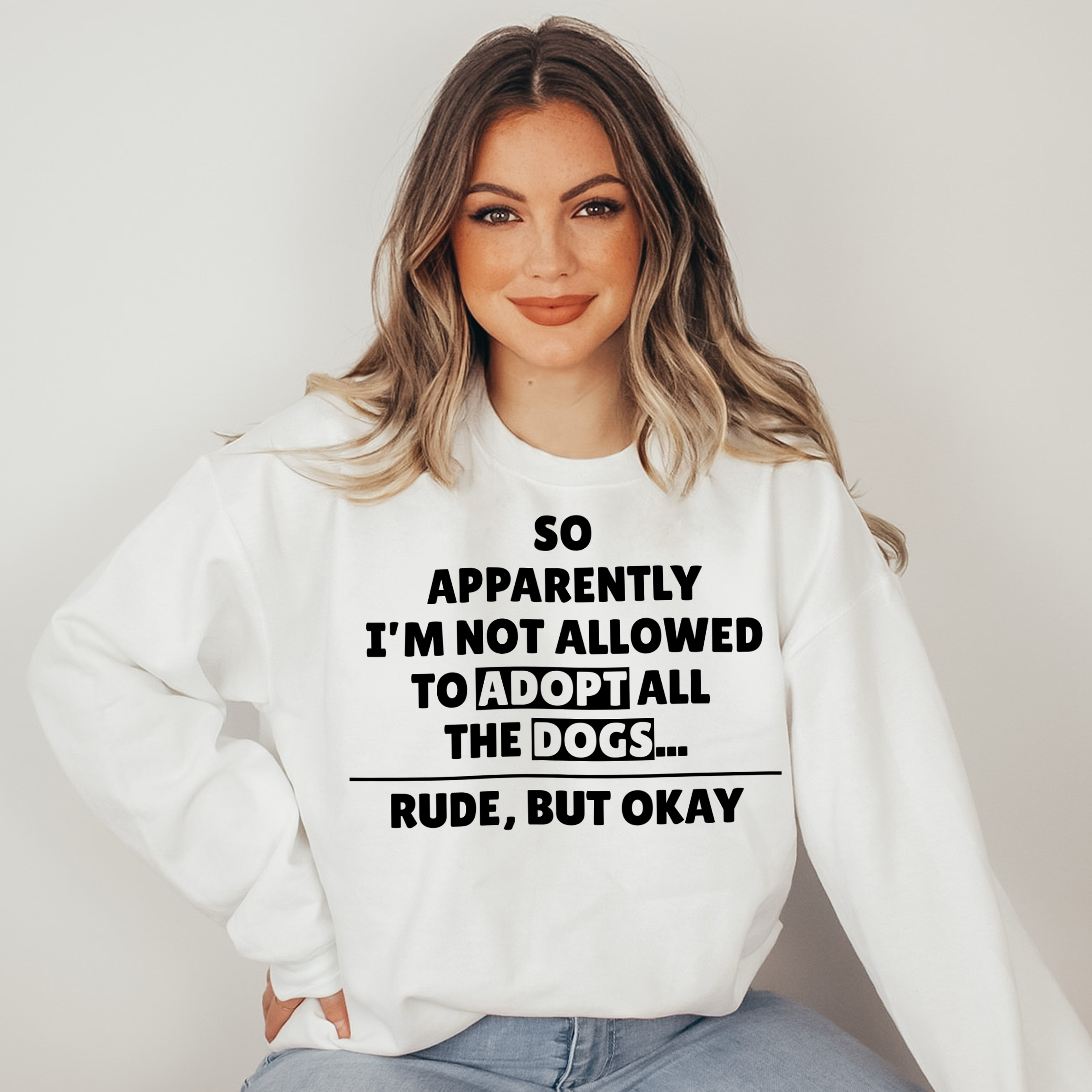 Woman wearing a white sweatshirt with text on a plain background