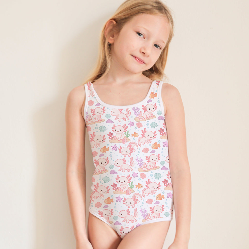 Young girl wearing a floral swimsuit against a plain background