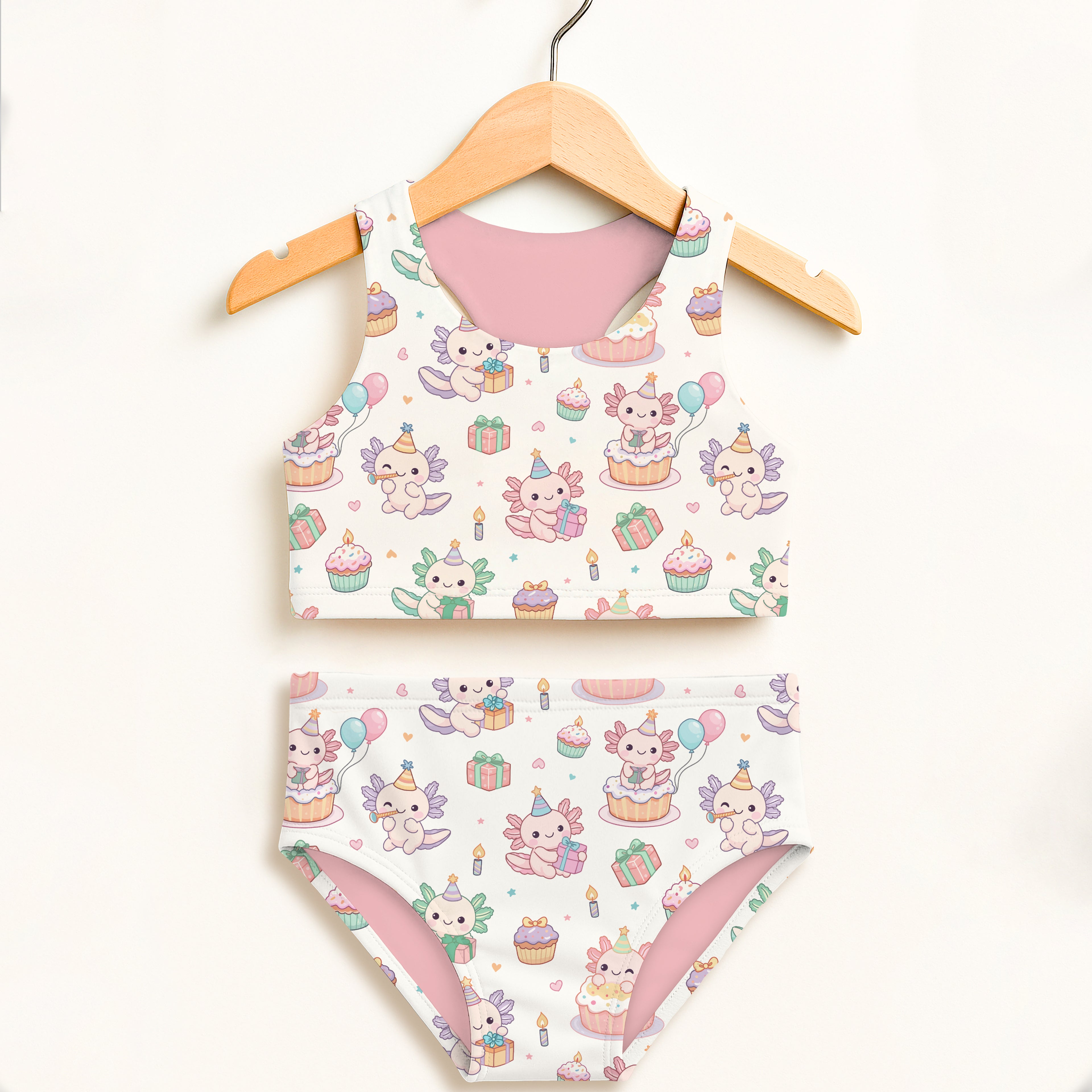 Girls axolotl birthday two-piece swimsuit with cupcake gift box and balloon motifs in white and pink with upf 50+ protection