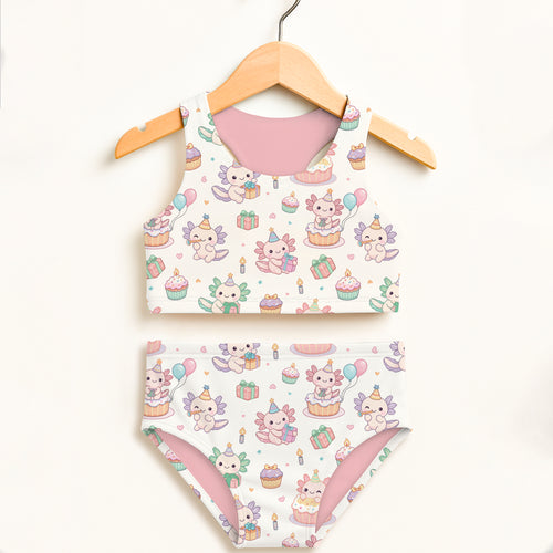 Girls axolotl birthday two-piece swimsuit with cupcake gift box and balloon motifs in white and pink with upf 50+ protection