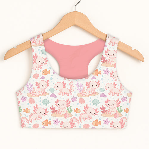 Girls axolotl sports bra in white with pink interior featuring pastel cartoon axolotls seashells and fish quick drying