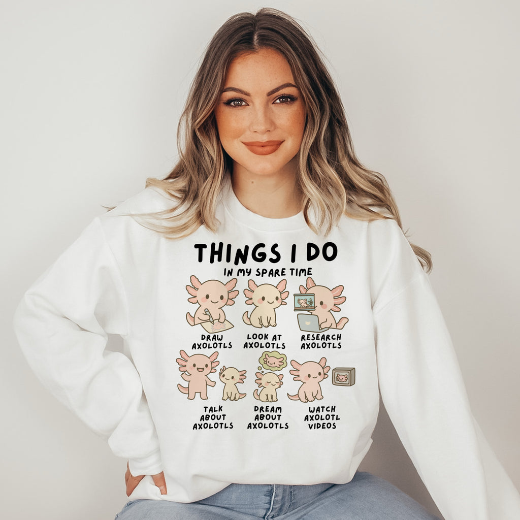 Woman wearing a white sweatshirt with axolotl illustrations and text.