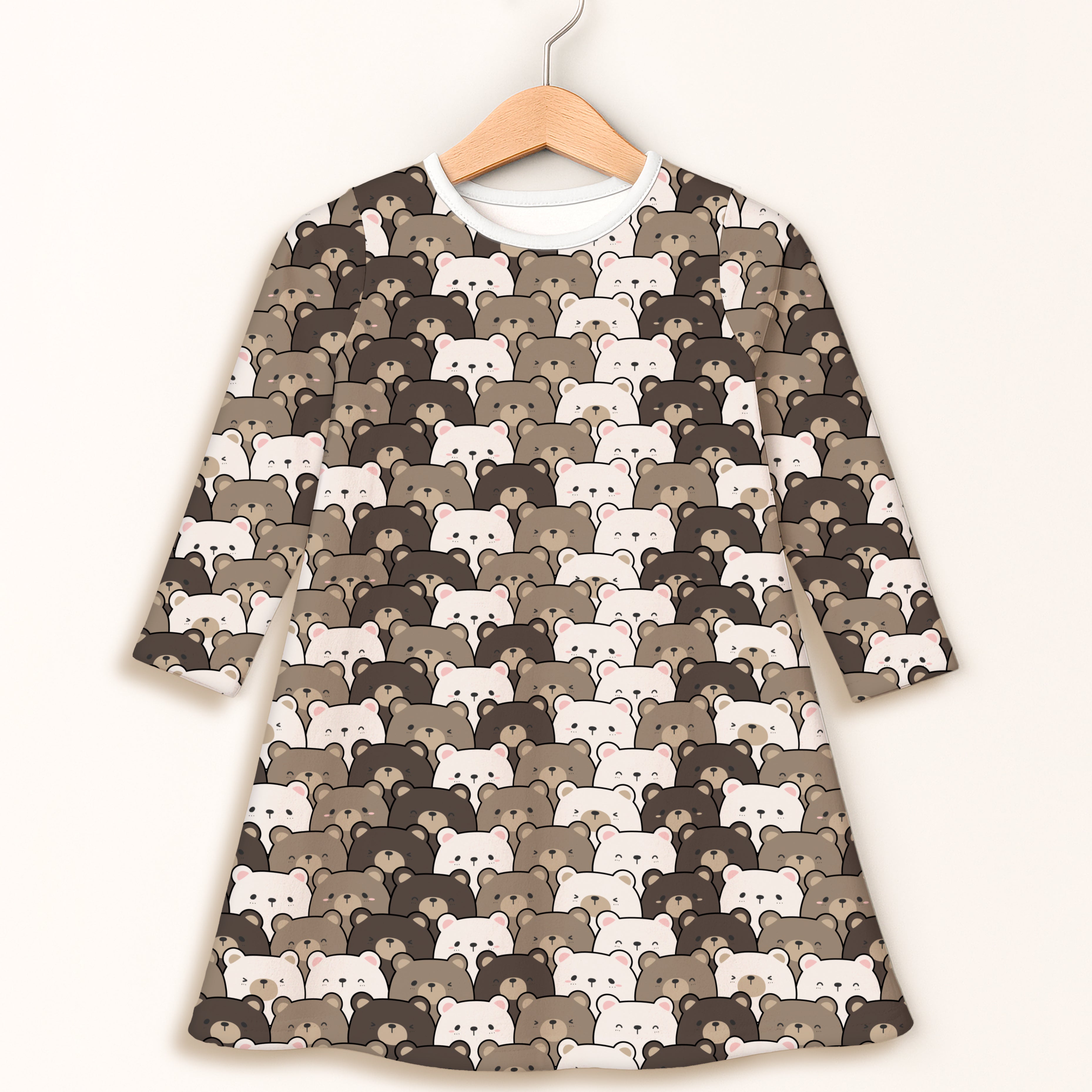 Girls brown long-sleeve dress with playful cartoon bear pattern hanging on wooden hanger