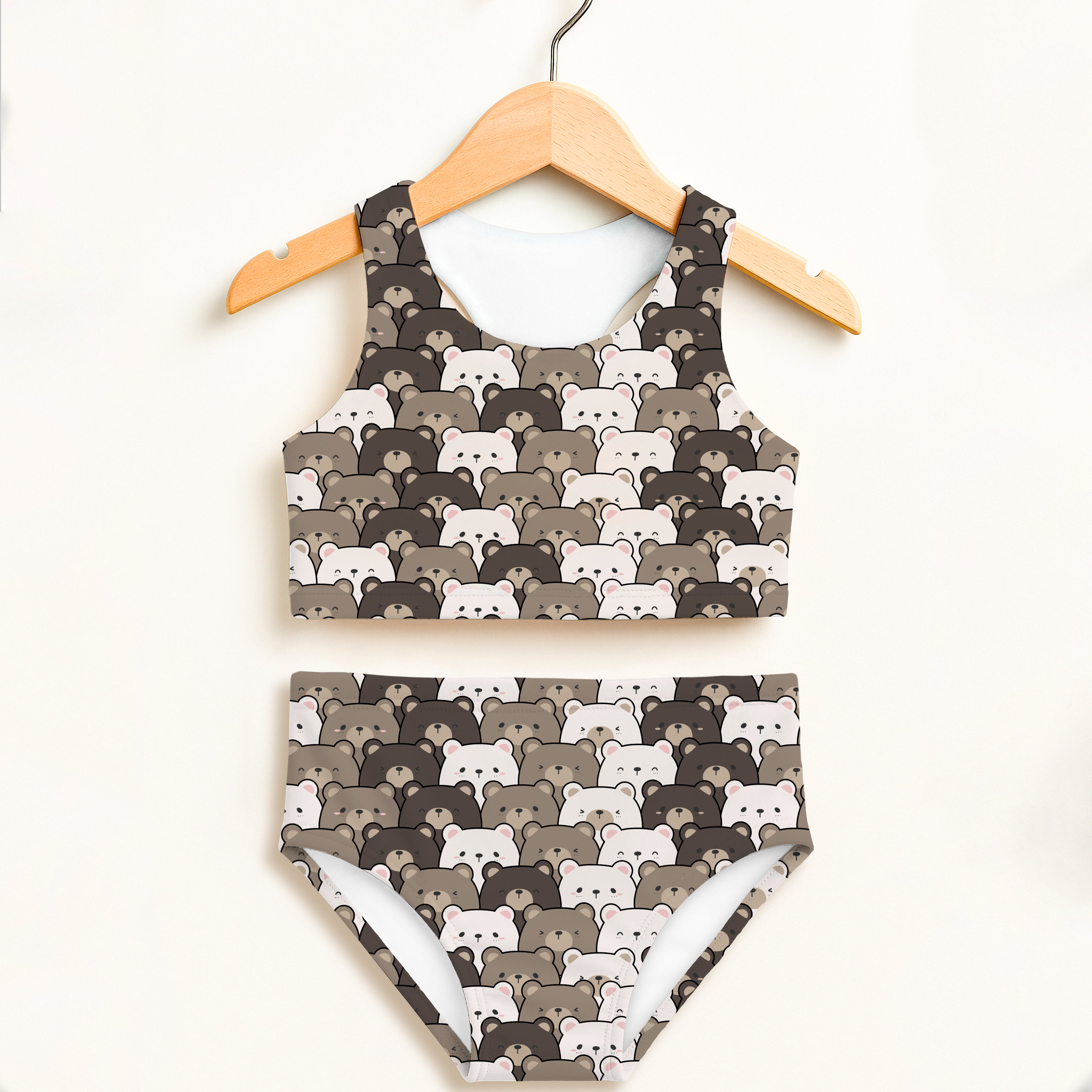 Girls bear face two piece swimsuit with brown and white cartoon bears on wooden hanger featuring upf 50 plus fabric