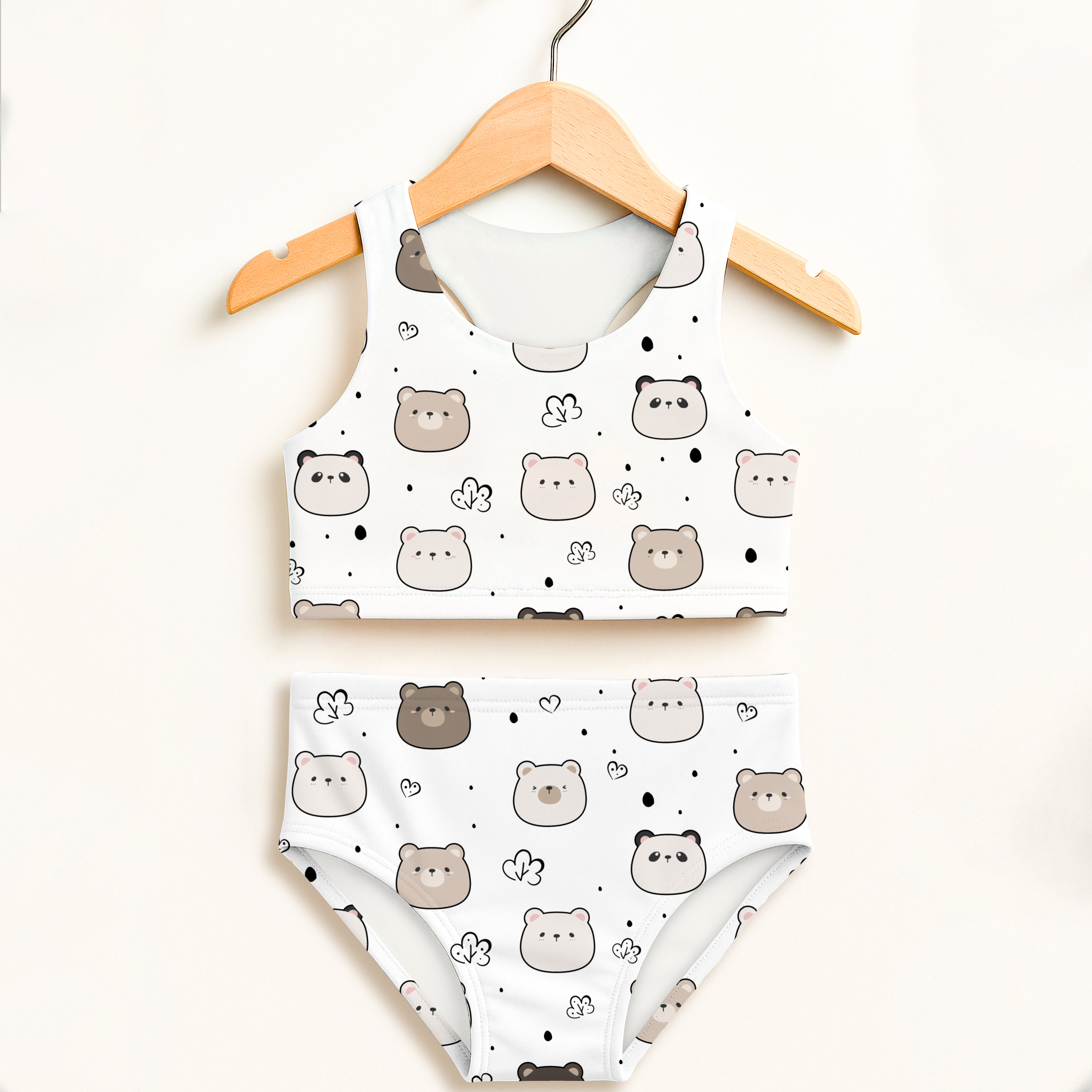 White two-piece girls swimsuit with playful gray and beige bear pattern, hearts, dots, double layered, upf 50+ high waisted comfort
