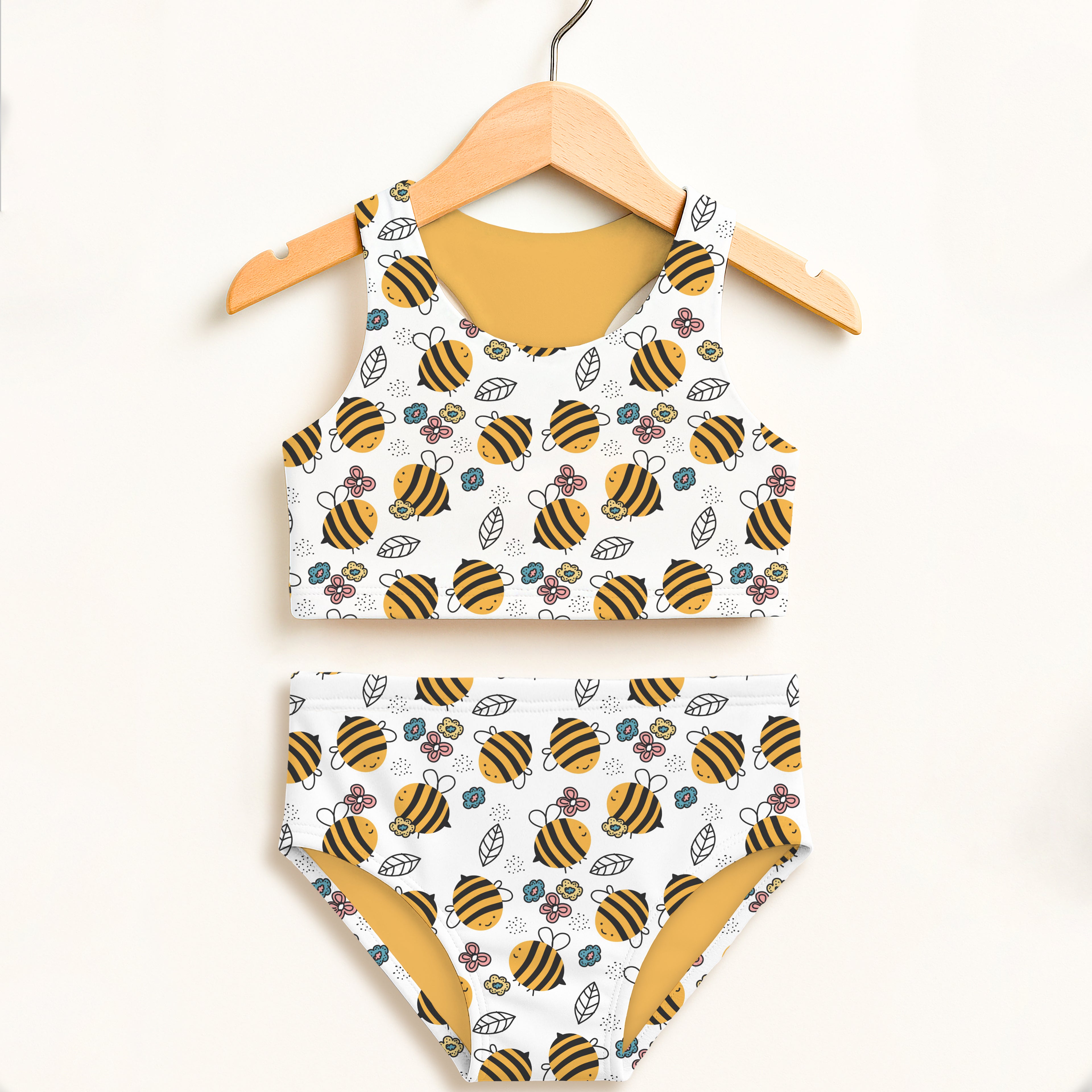 Girls floral yellow bumblebee two piece swimsuit with playful bee and flower pattern and mustard yellow lining
