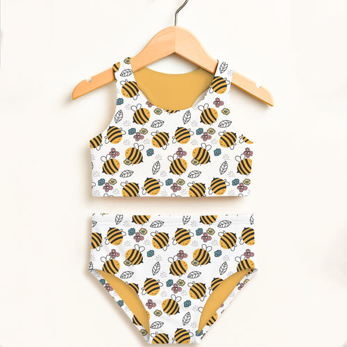 Girls floral yellow bumblebee two piece swimsuit with playful bee and flower pattern and mustard yellow lining