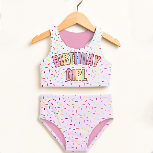 Pastel pink and white two-piece swimsuit with rainbow sprinkle print and birthday girl text double layered upf 50+ high waisted