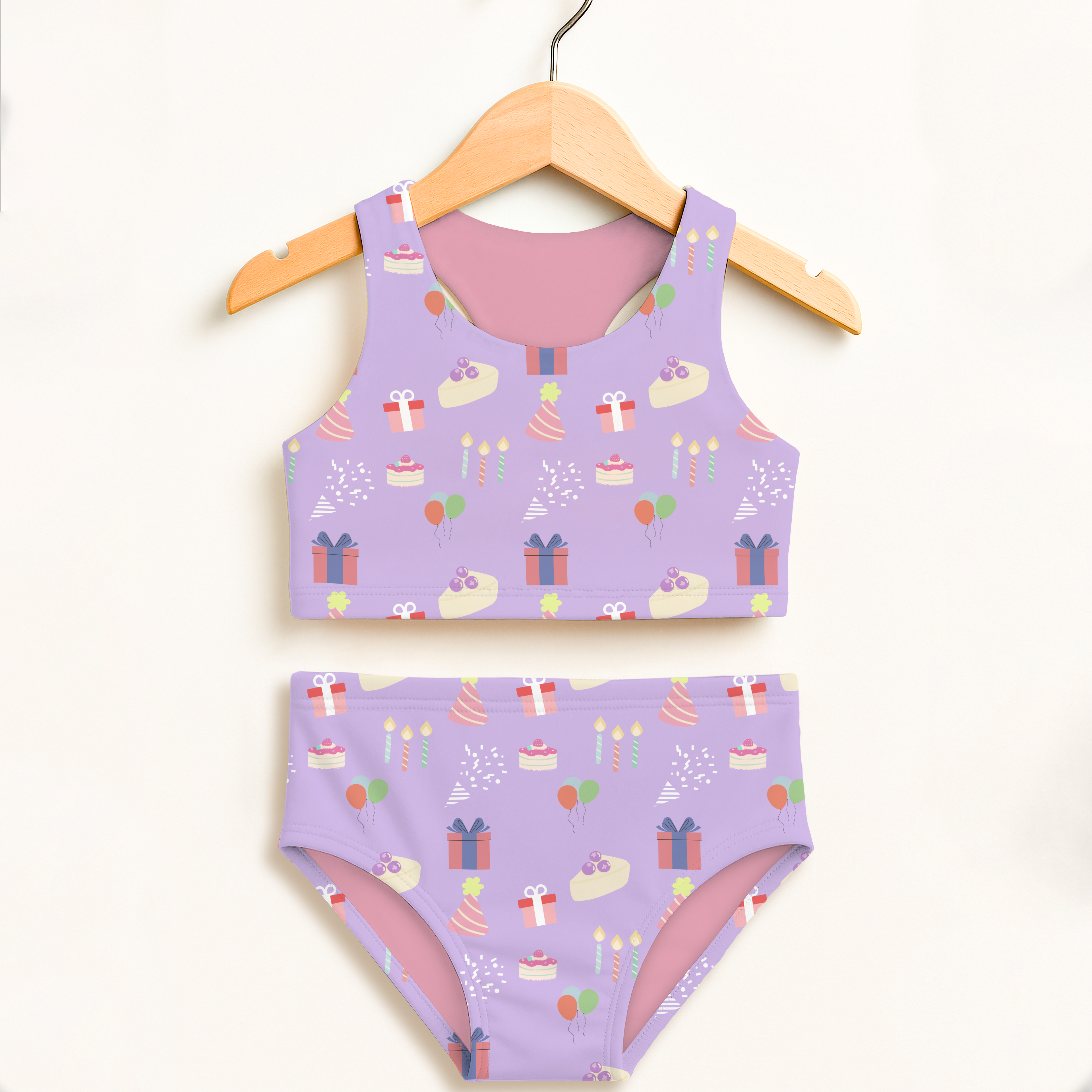 Girls purple birthday pattern two-piece swimsuit with playful cakes gifts balloons design and double layered UPF 50+ fabric