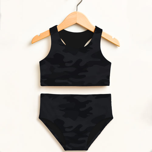 Girls black camouflage two piece swimsuit set hanging on wooden hanger with double layered upf 50 plus fabric