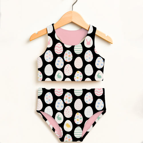 Girls black and pink easter egg two piece swimsuit with colorful eggs and bunnies pattern and UPF 50+ high waisted comfort