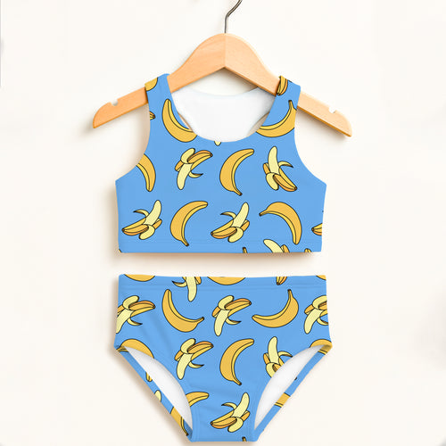 Girls blue banana-print two-piece swimsuit hanging on wooden hanger with double layered upf 50+ high waisted comfort