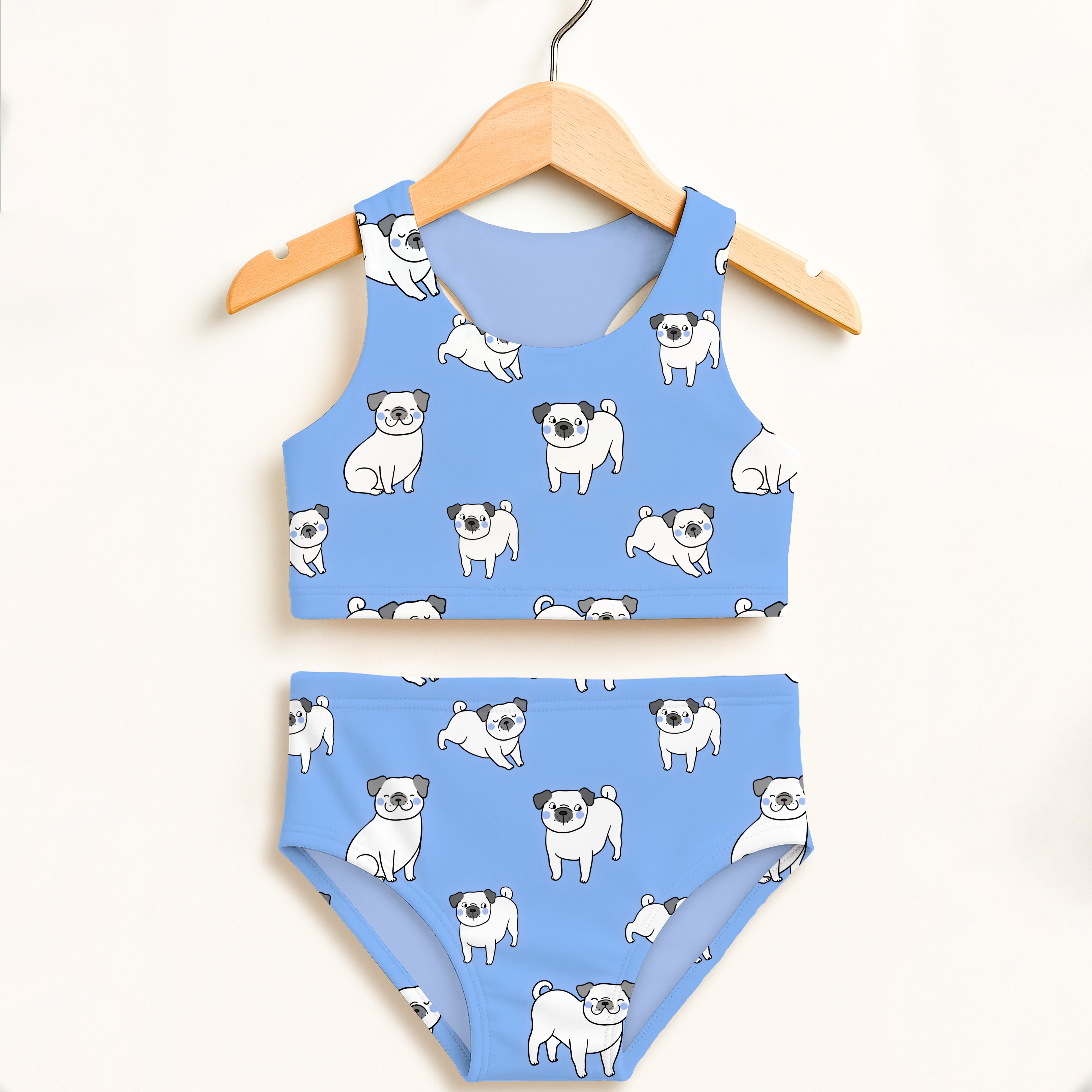 Girls blue pug two piece swimsuit with playful white cartoon pugs double layered UPF 50 plus high waisted comfort