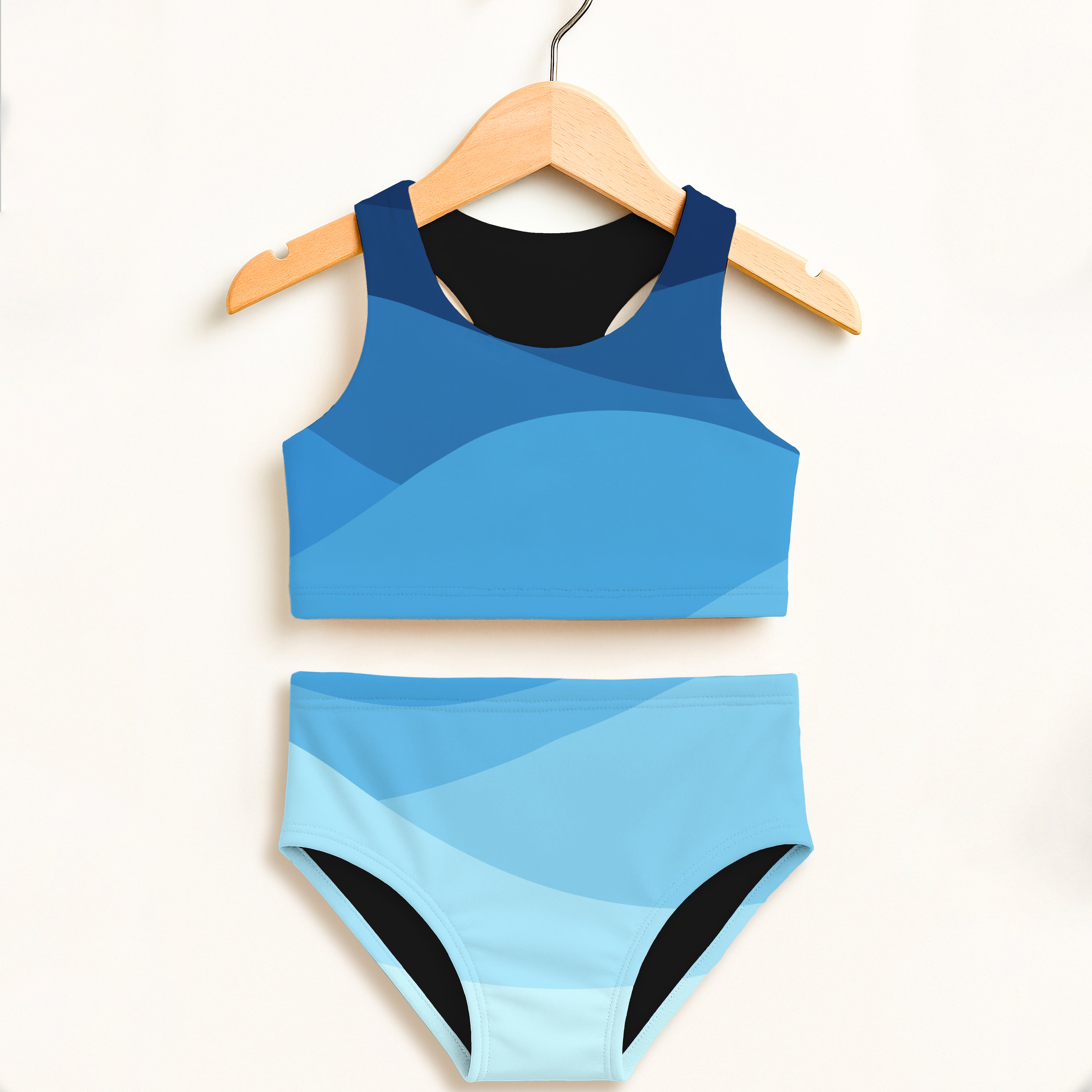 Girls blue waves two piece swimsuit with blue gradient and black trim featuring double layered UPF 50+ fabric
