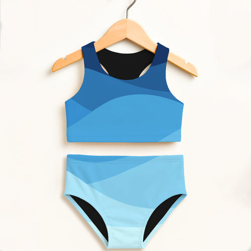 Girls blue waves two piece swimsuit with blue gradient and black trim featuring double layered UPF 50+ fabric