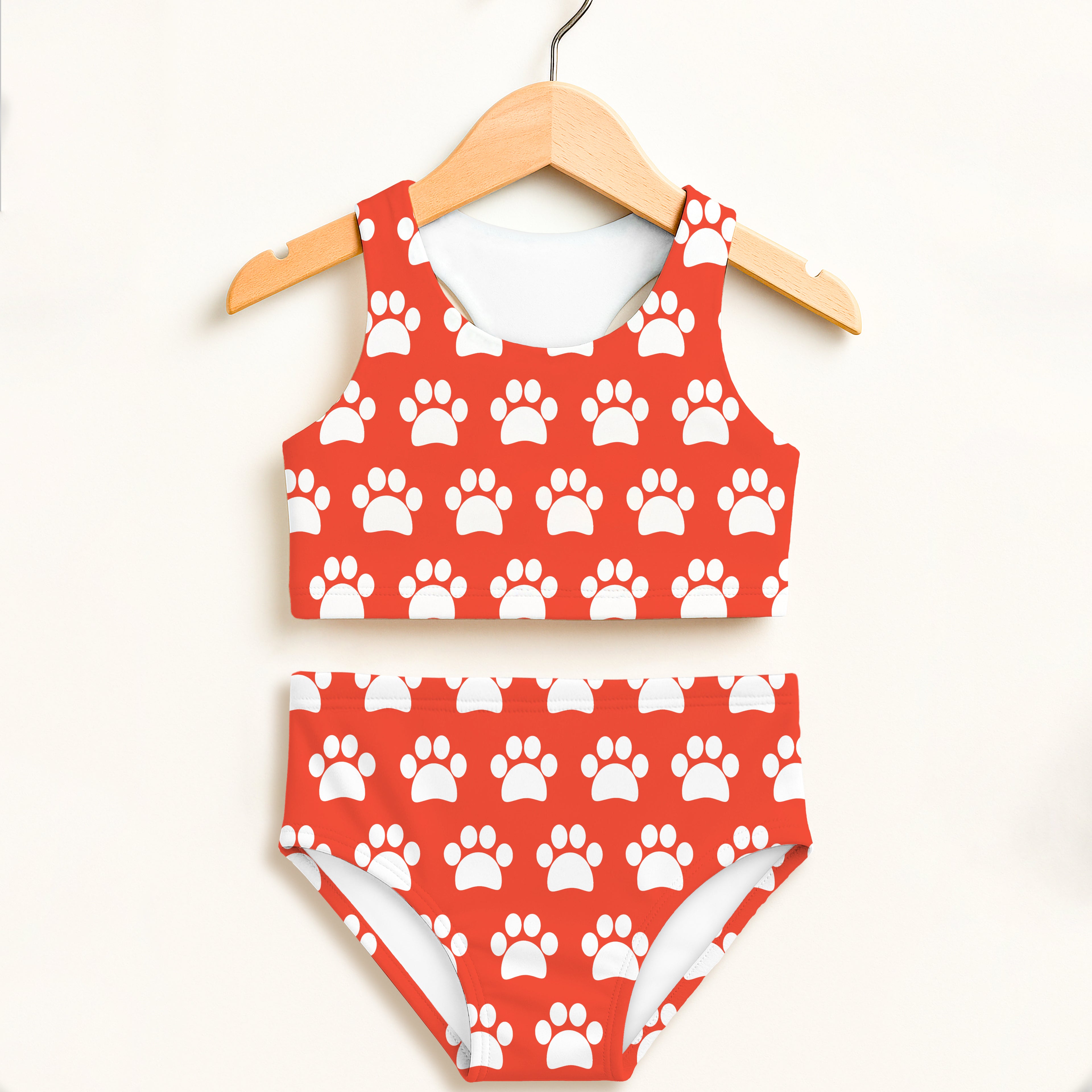 Girls bright orange two piece swimsuit with red and white paw print pattern double layered upf 50 high waisted comfort