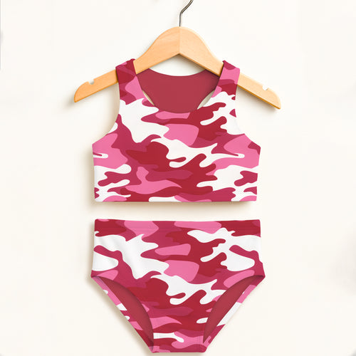 Girls bright pink and white camouflage two piece swimsuit hanging on wooden hanger with upf 50+ high waisted comfort