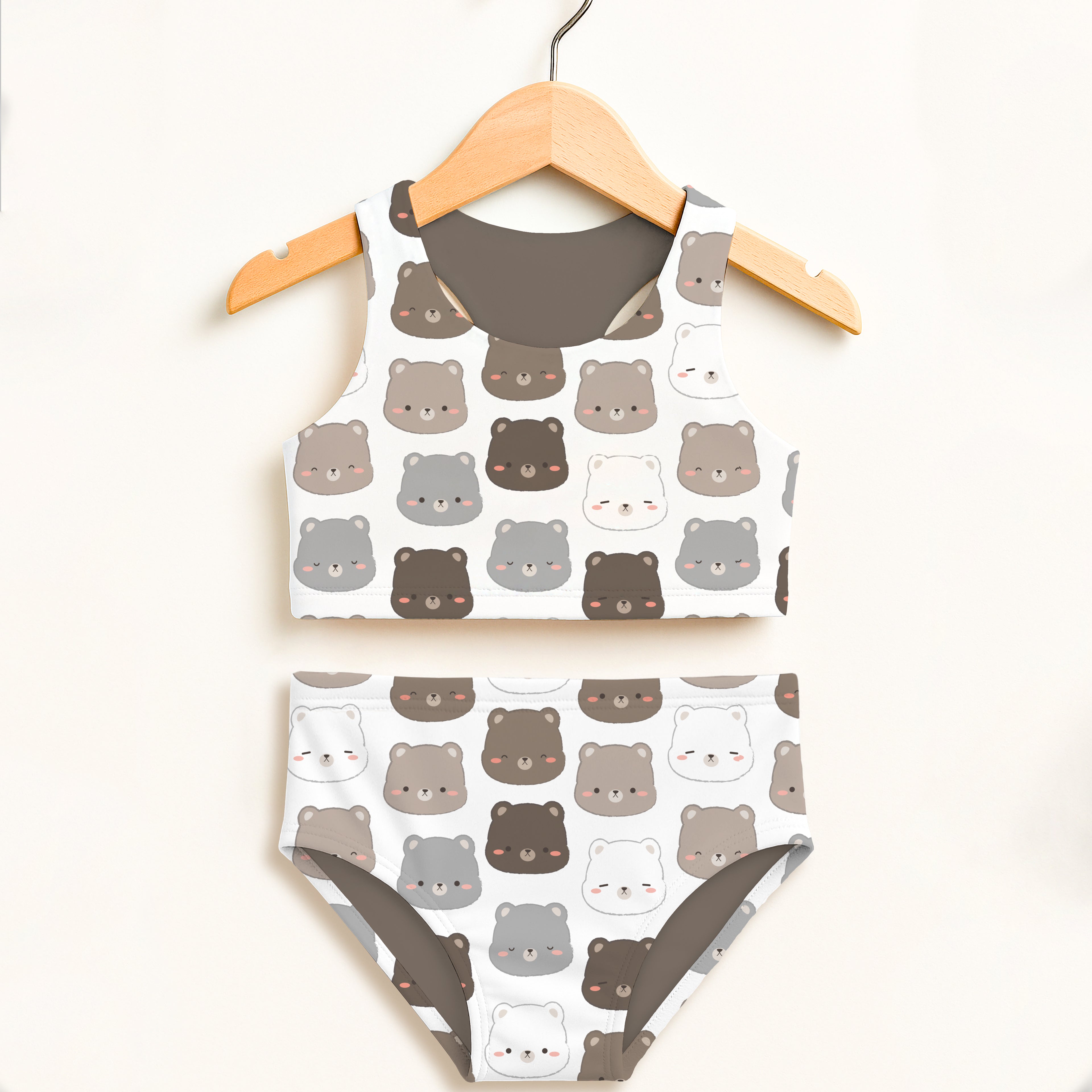 Girls brown bear two piece swimsuit in white with playful cartoon bear pattern and double layered upf 50+ fabric