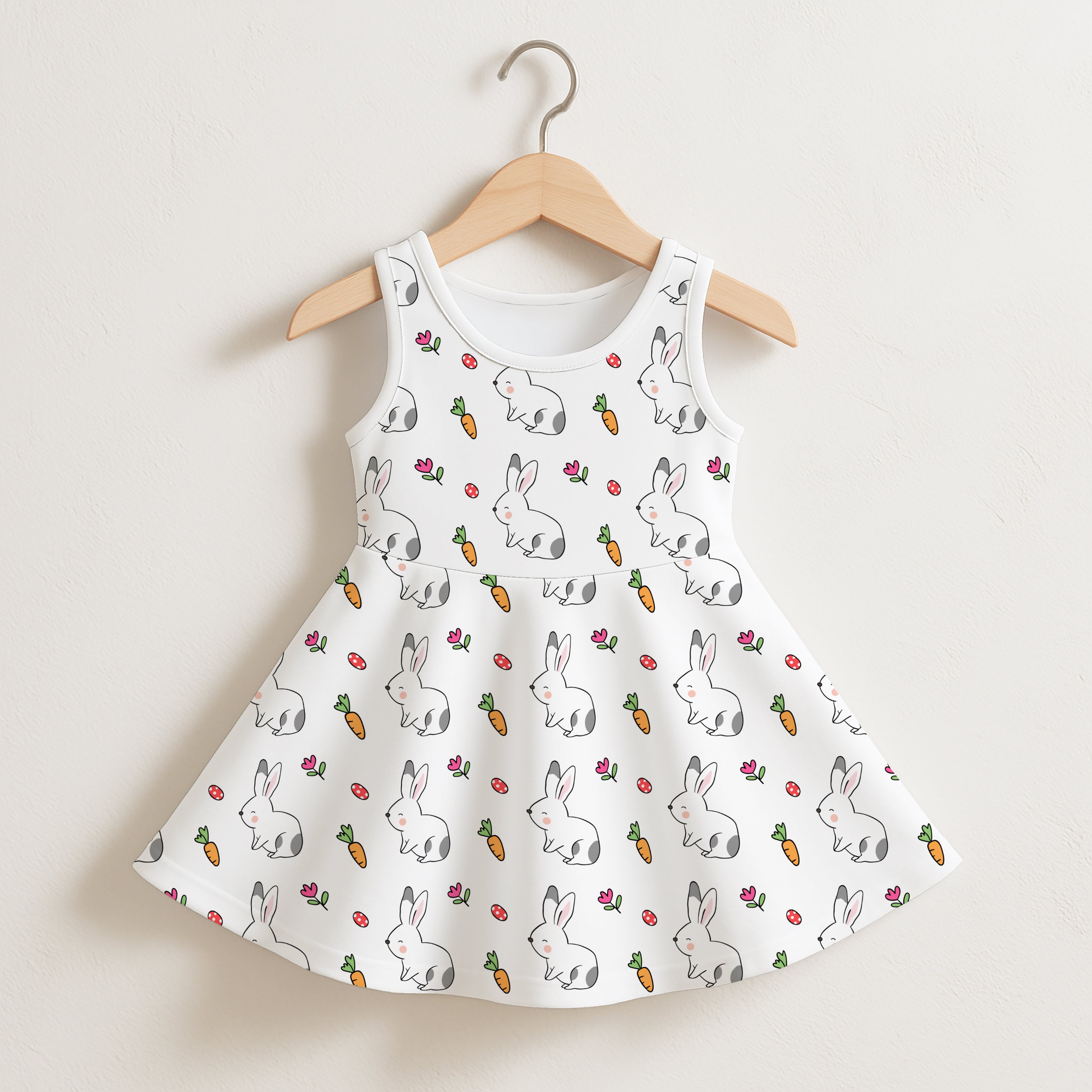 White sleeveless girls dress with playful gray bunnies orange carrots and pink flowers pattern for casual wear