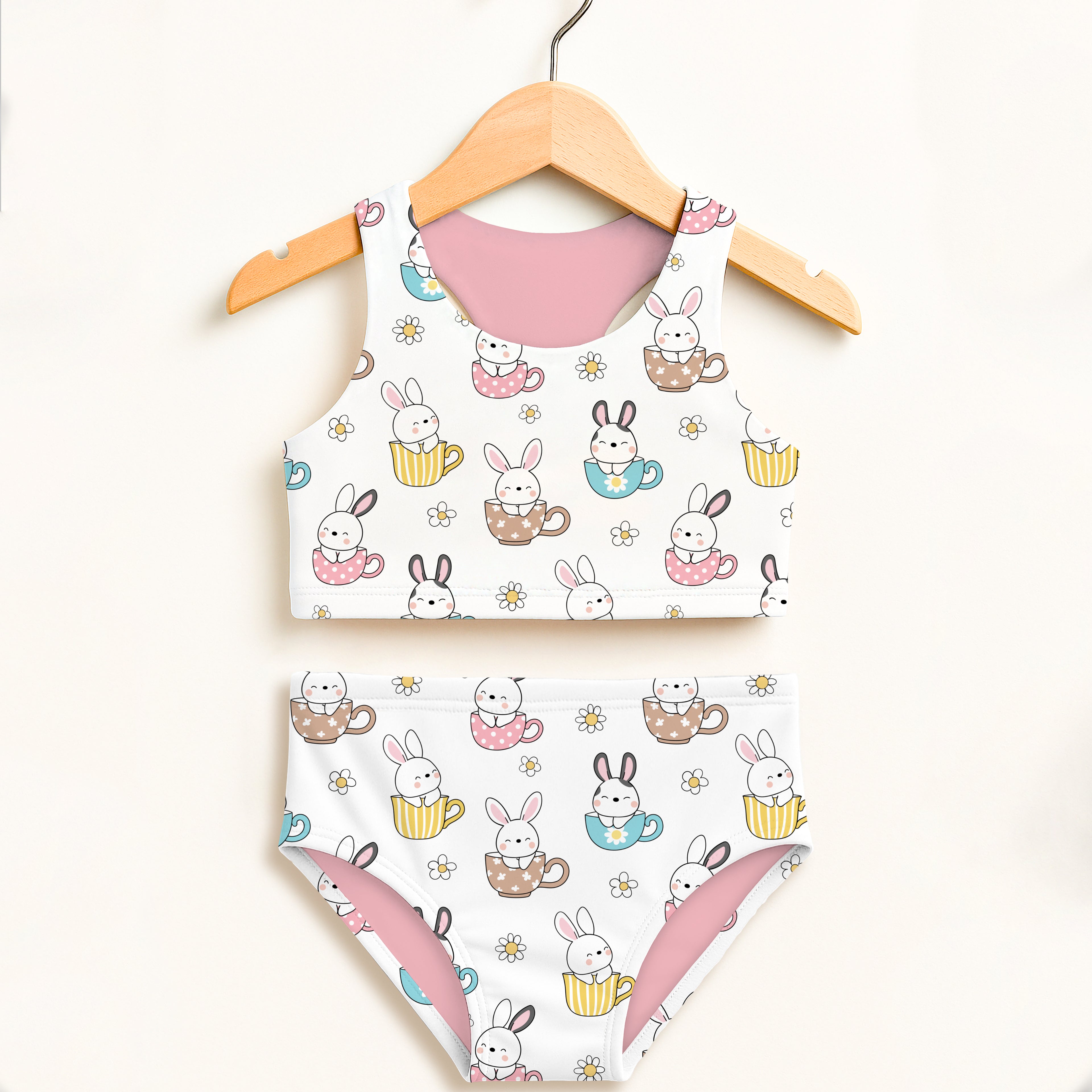 Girls bunny teacup two piece swimsuit in white with pink lining and colorful yellow blue and brown teacups design